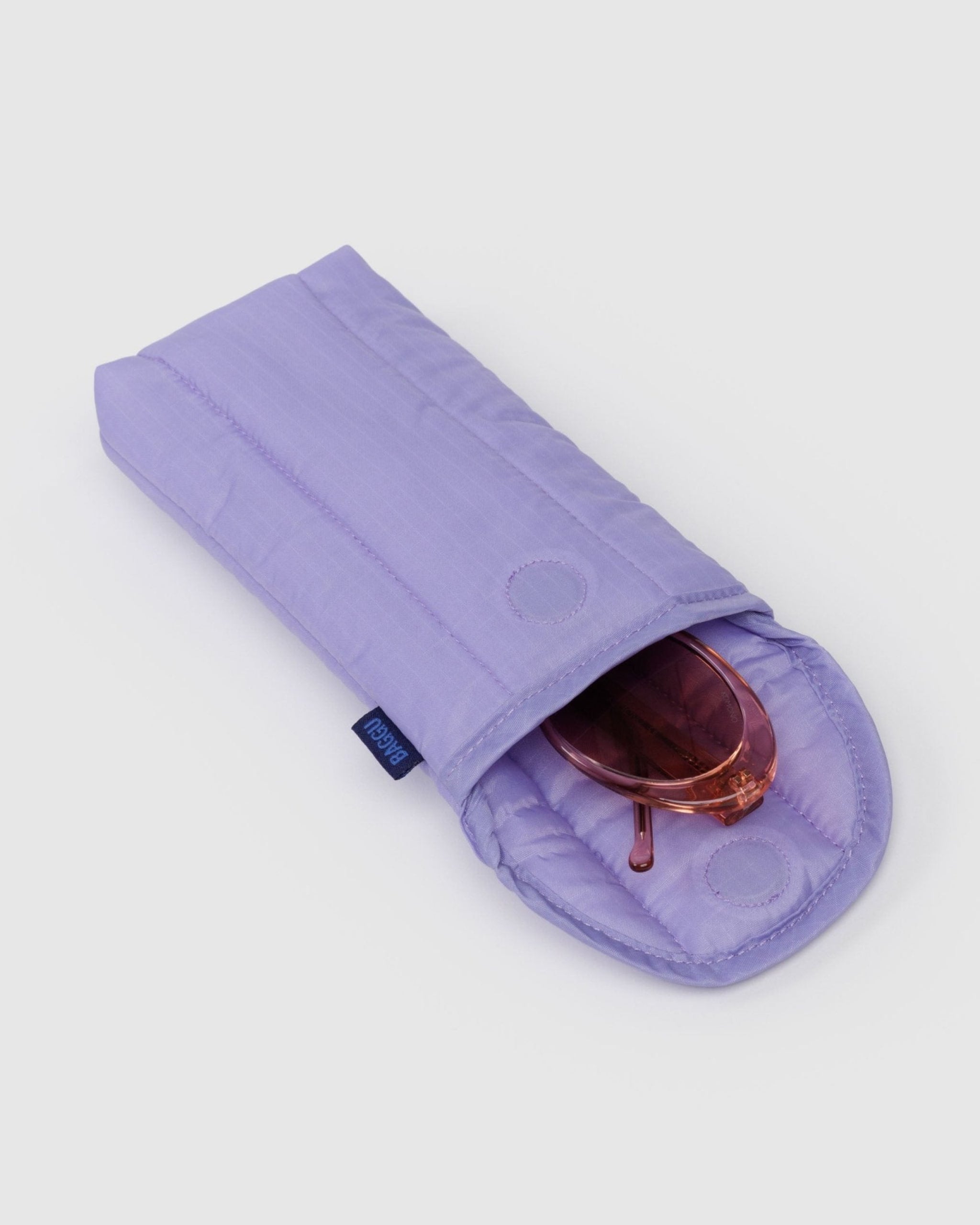 Quilted purple sunglass case with magnetic closure and sunglasses inside.