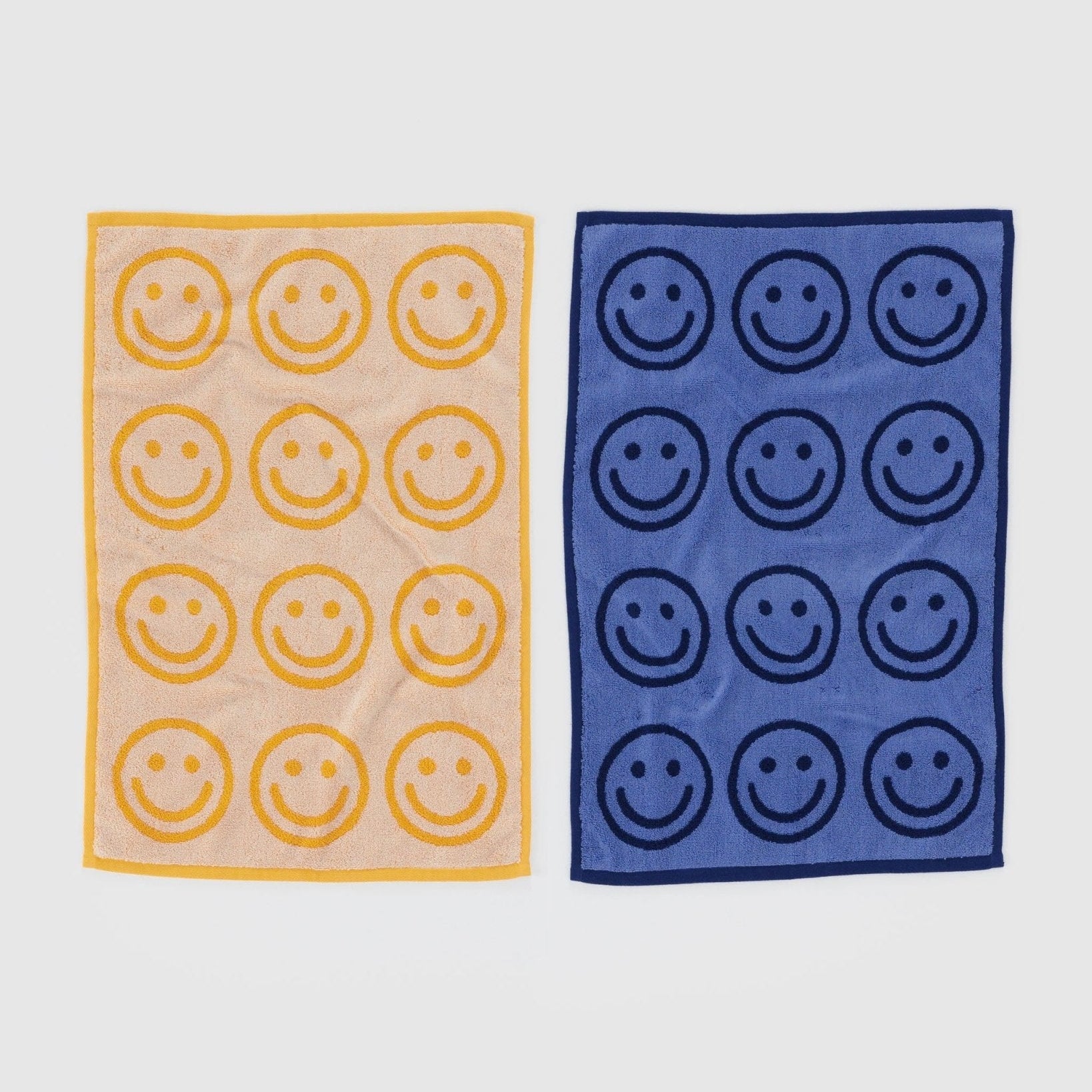 front of blue and a yellow towel with smiley face print
