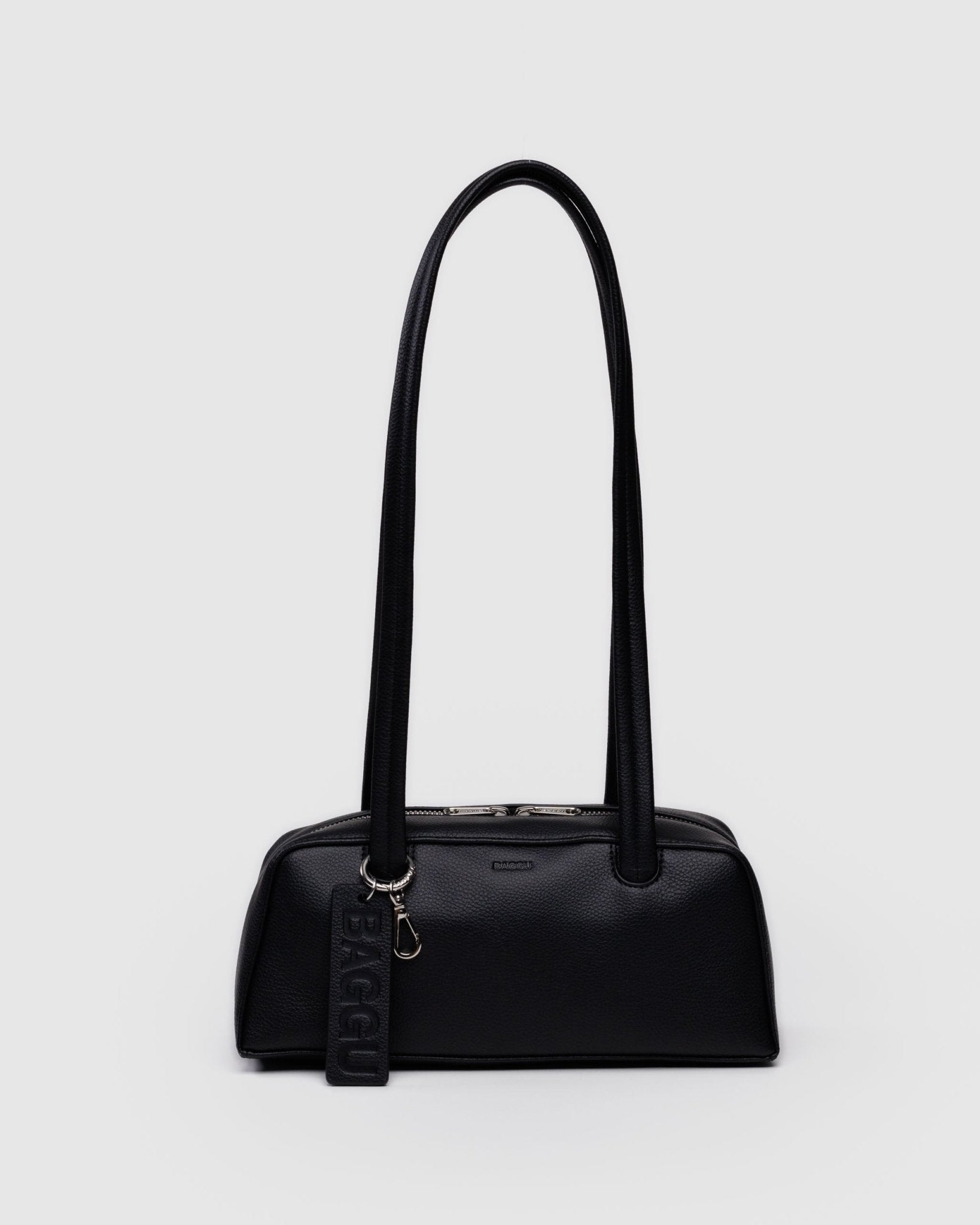 Black leather small bowler bag with double handles and zips and a metal clip.