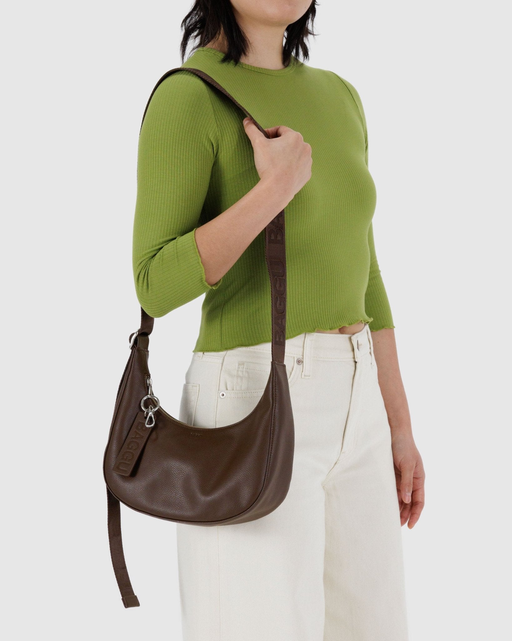 Woman carrying a Brown Small Recycled Leather Crescent Bag on shoulder - ANNIE.G