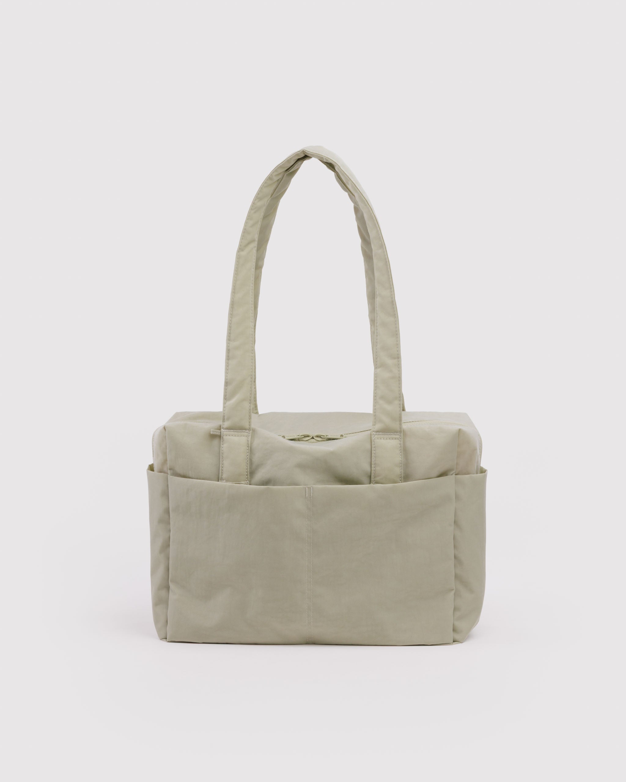 Light green duffle bag with double top zippers, two carry handles and exterior pockets.