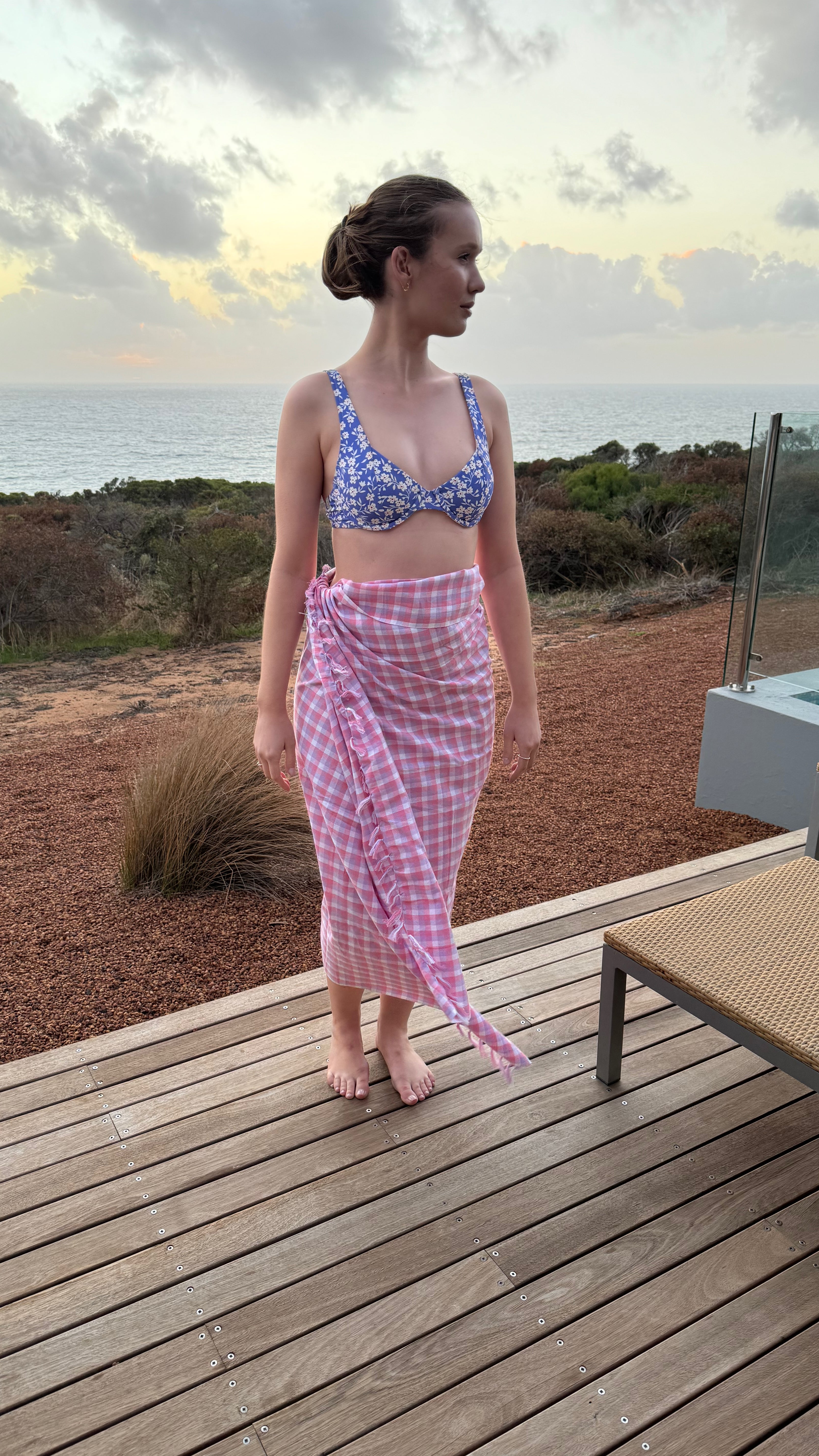 woman-wrapped-in-peony-check-cotton-beach-towel-as-a-sarong