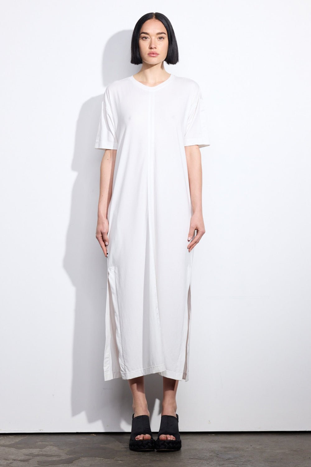 Woman wearing a white t-shirt dress with short sleeves and side splits -Solange Dress - ANNIE.G