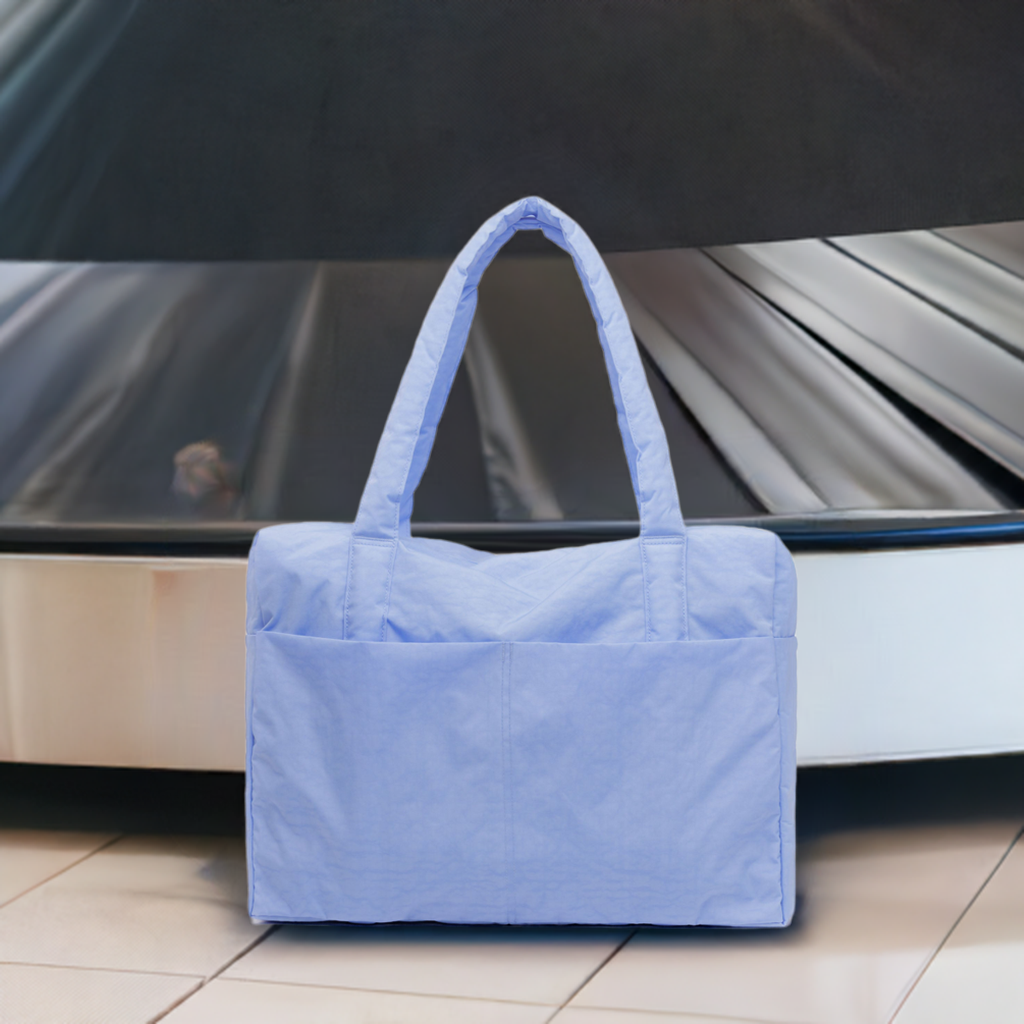 french-blue-small-cloud-carry-on-near-airport-bag-collection-belt