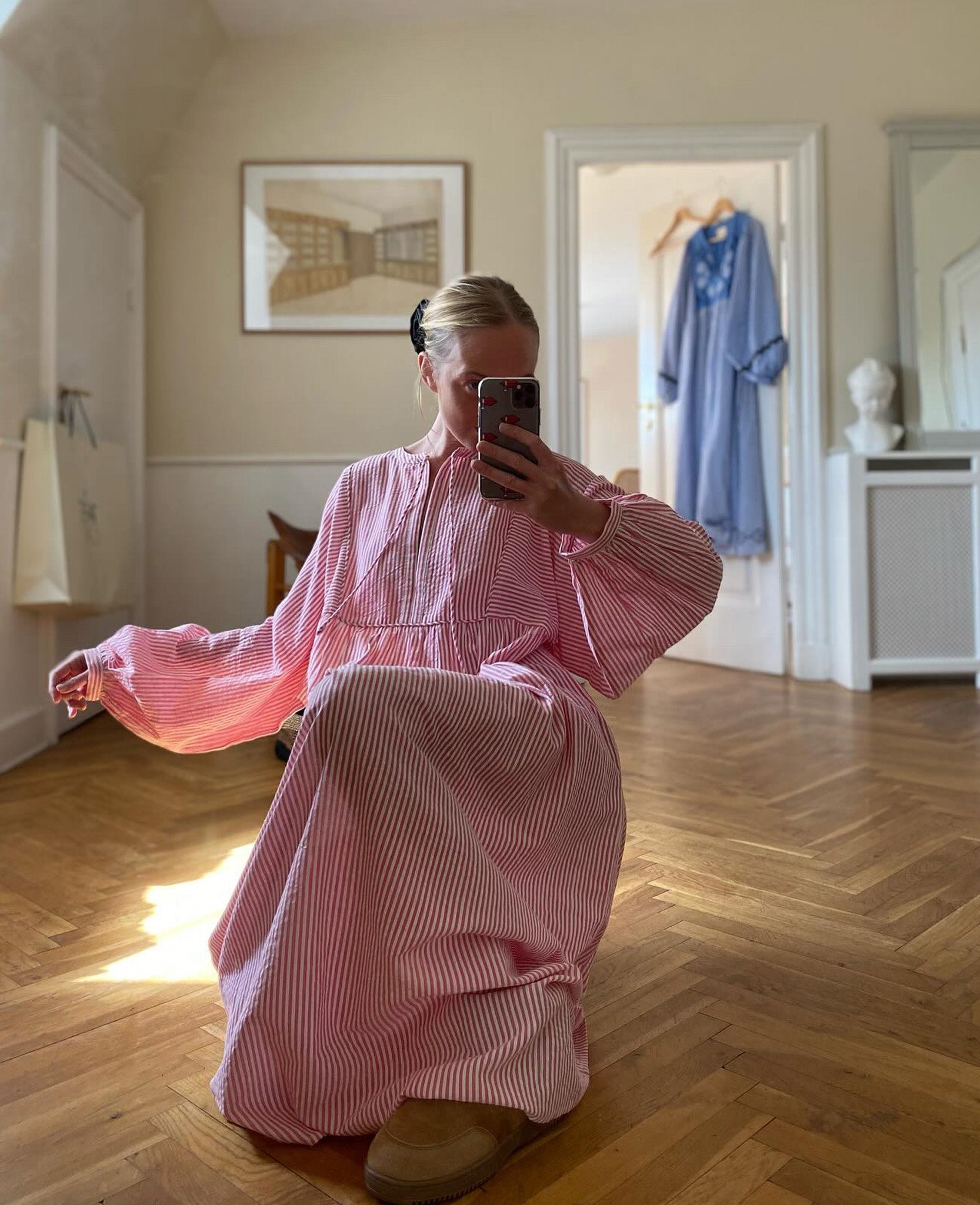 Woman kneeling and taking a selfie in red and white stripe maxi dress - ANNIE.G