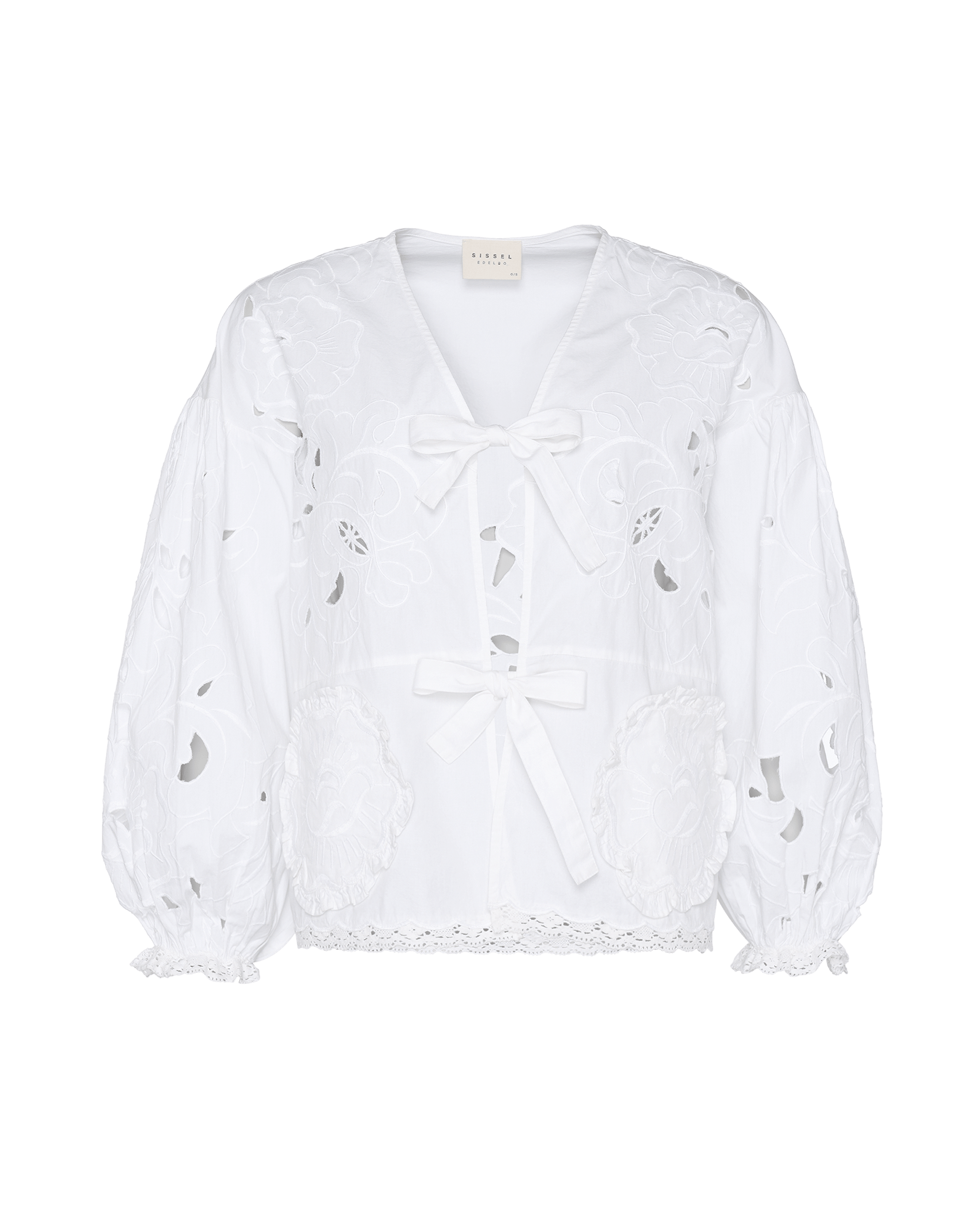 Front of white top with long sleeves and front ties with cutwork embroidery.