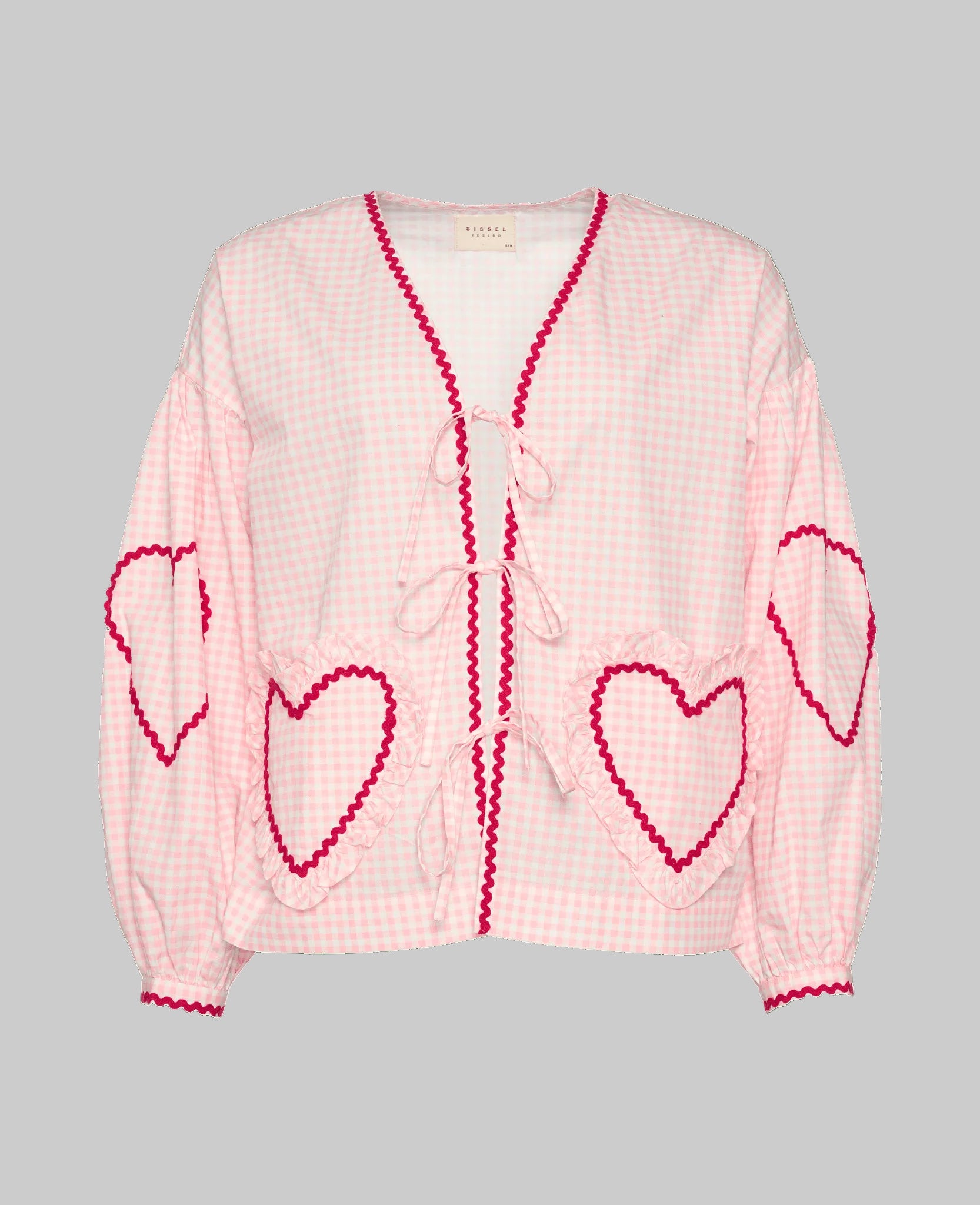 women's pink checked long sleeve blouse with heart shaped pockets and front tie closure with red ric rac detail.