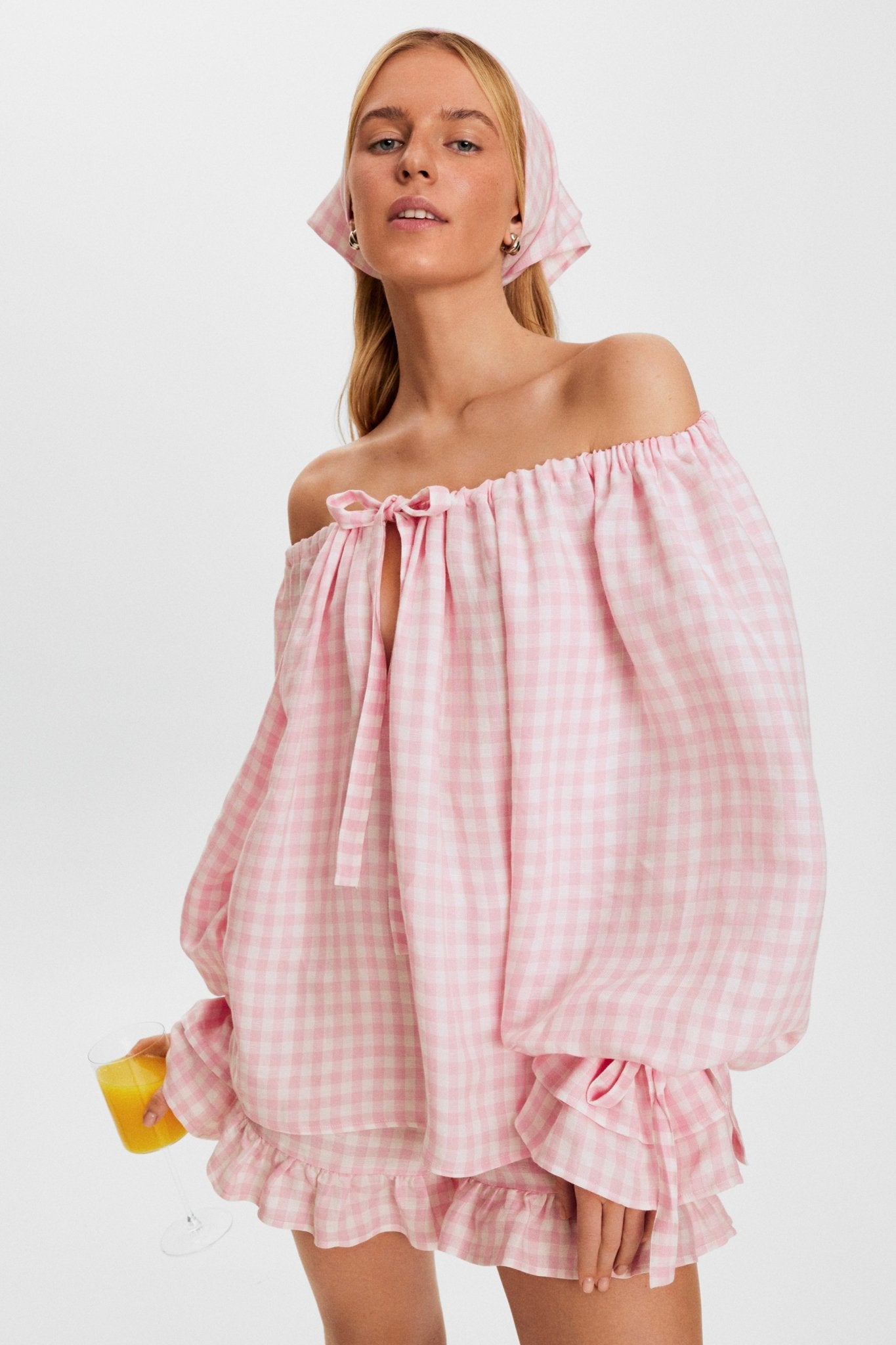 woman-wearing-pink-vichy-linen-blouse-off-the-shoulder-with-adjustable-ties-long-sleeves-and-matching-shorts-and-headscarf