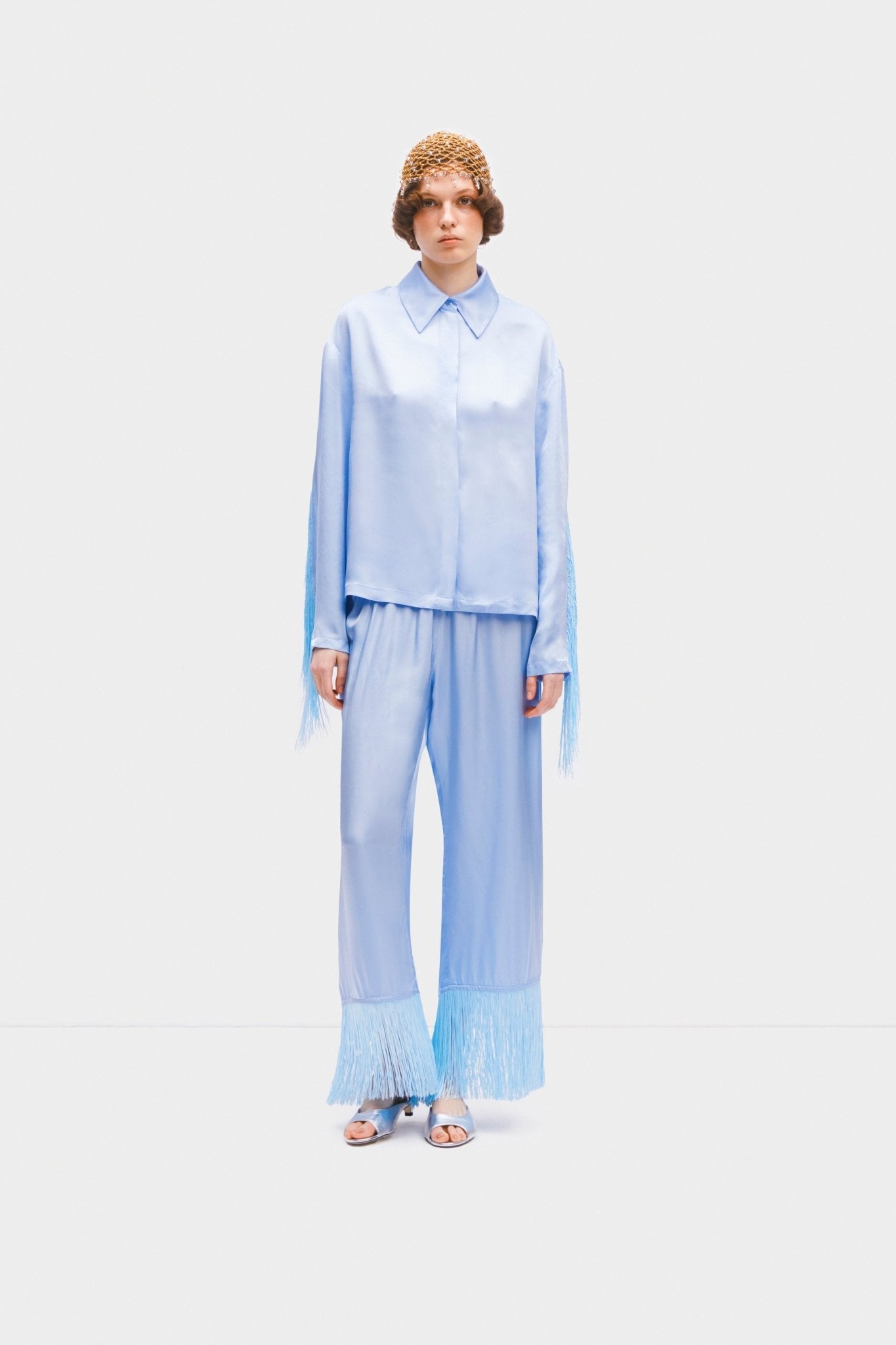 Person wearing blue Cosmic Cowboy Fringed Pyjama Set and gold crocheted mystic hat - ANNIE.G