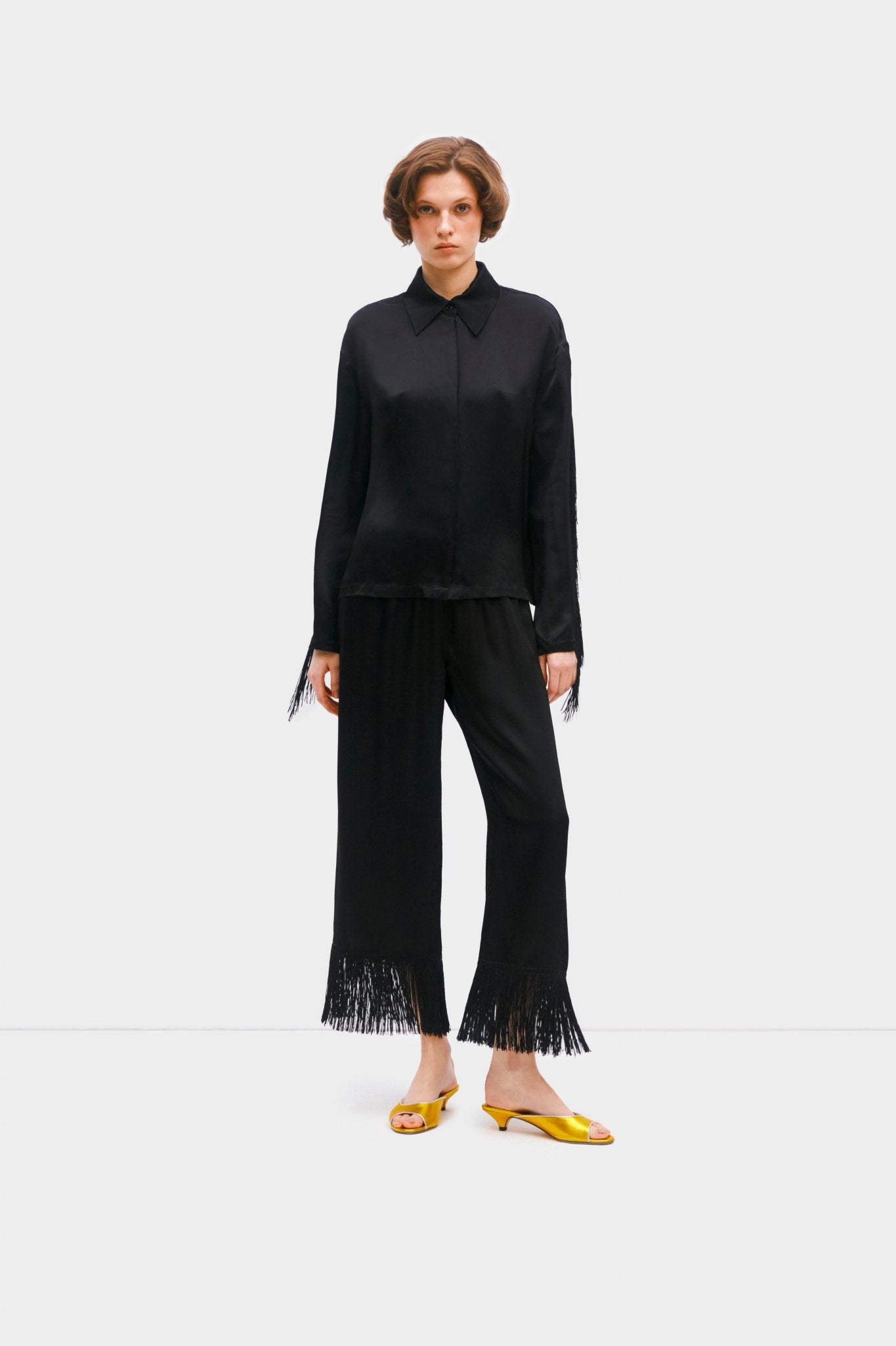 Woman wearing black fringed shirt and pants- ANNIE.G
