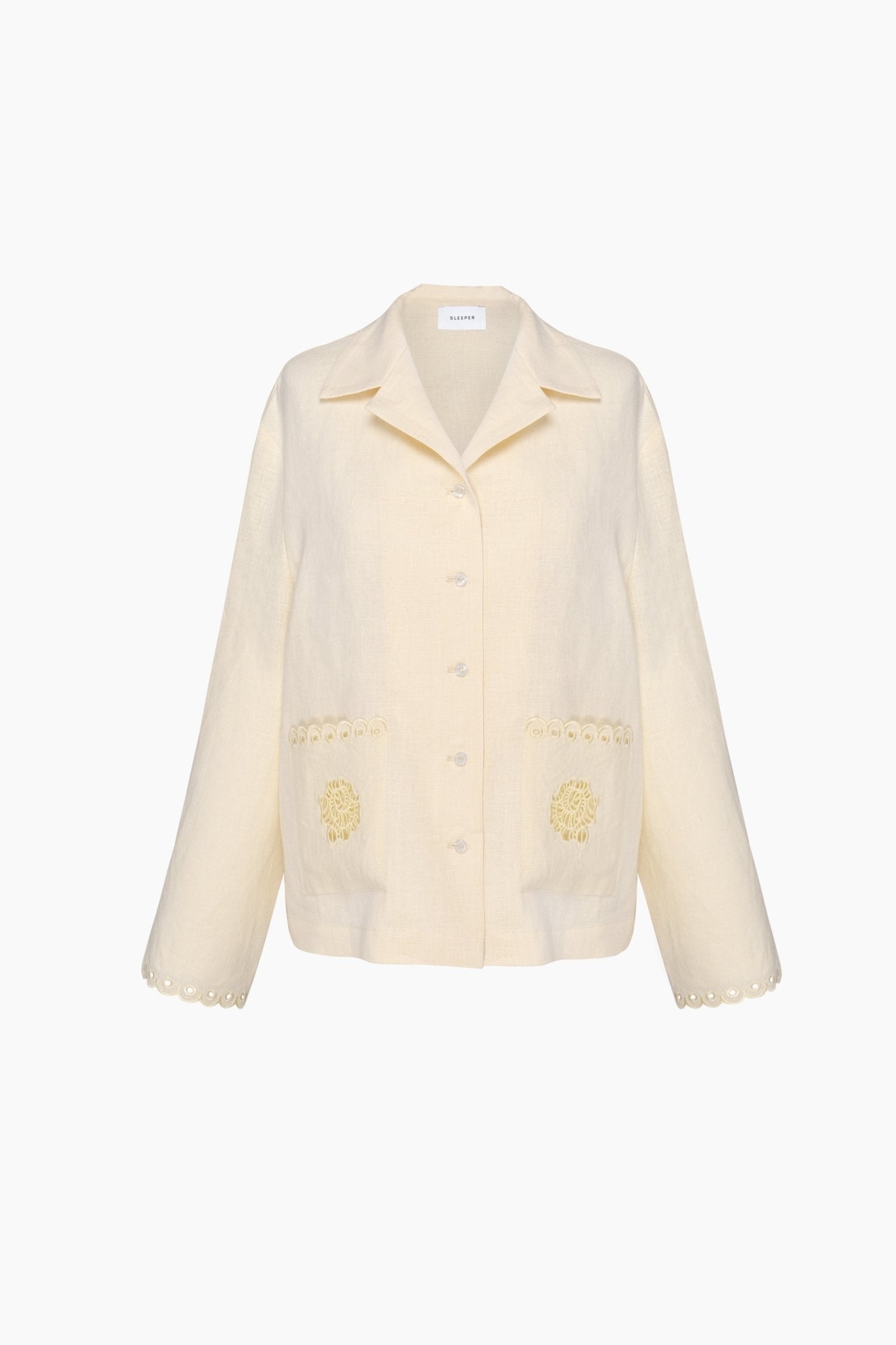 Cream linen loungewear shirt with long sleeves, pockets and embroidery detail.