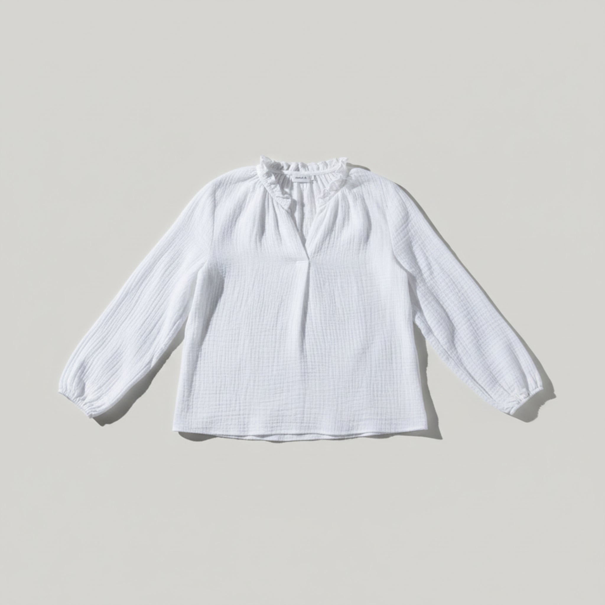 White cotton gauze v-neck women's top with long sleeves and elasticated cuffs flatlay - ANNIE.G