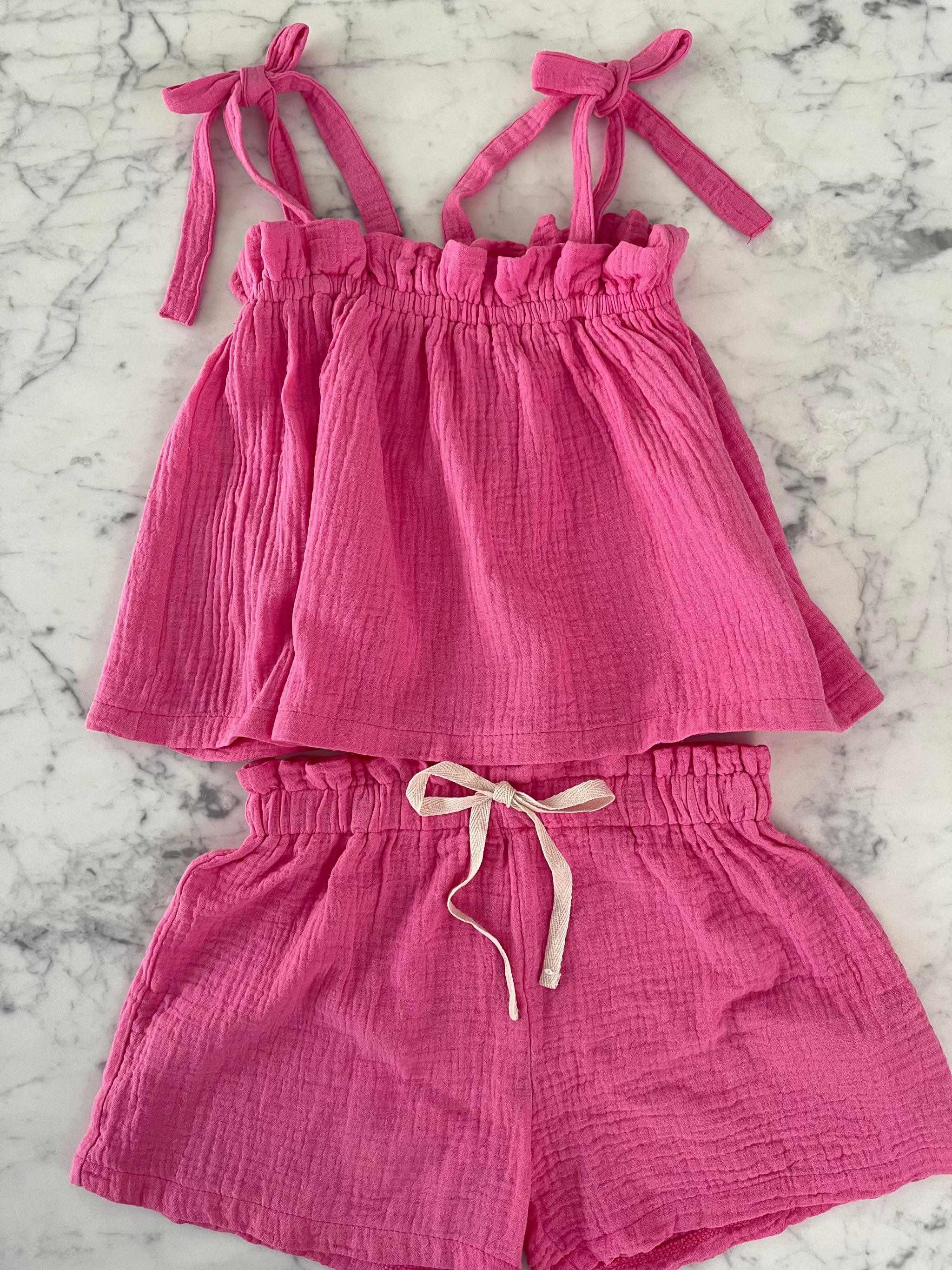 girls-hot-pink-shorts-and-top-set-for-summer-on-table.