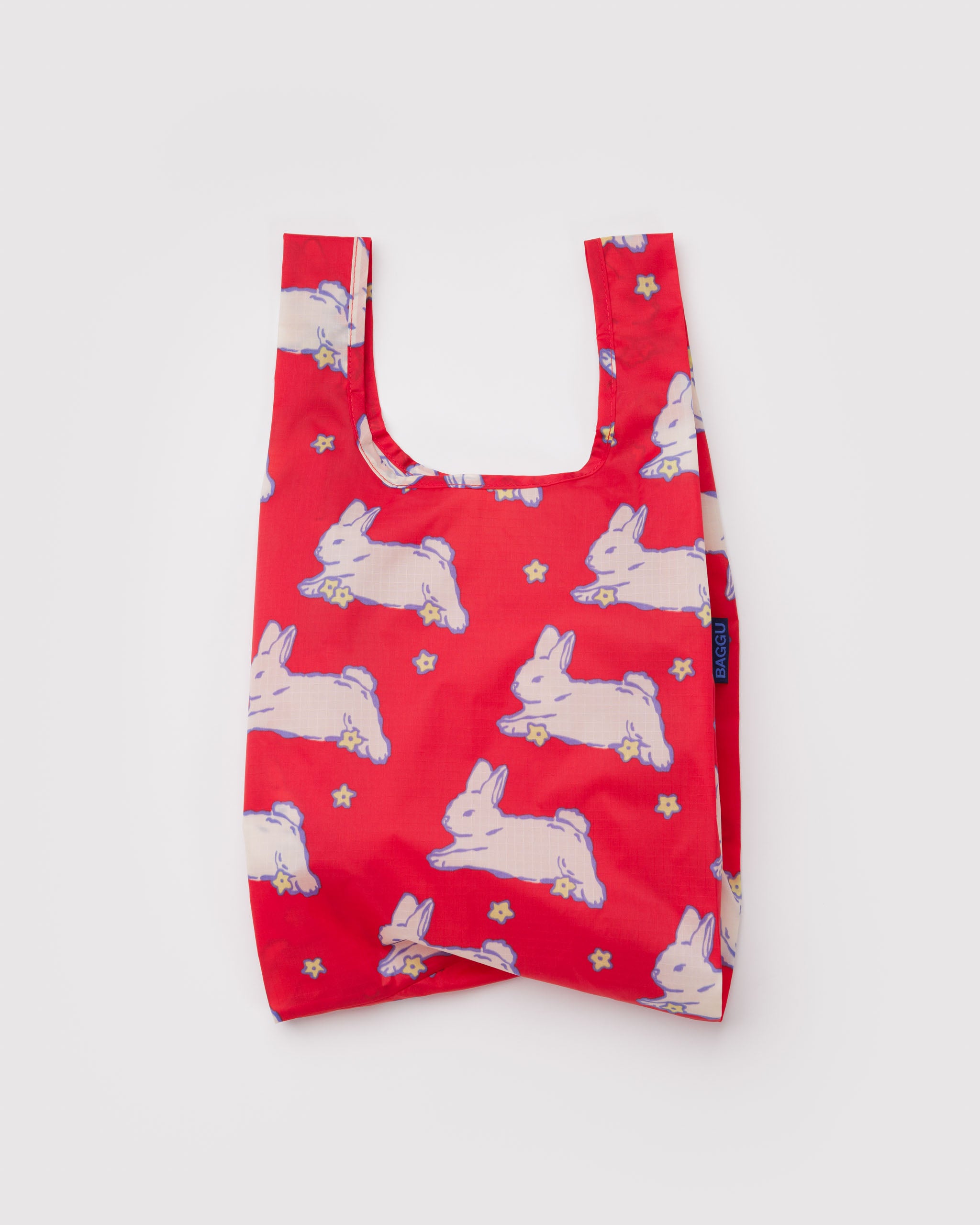 Red reusable shopping tote bag with white rabbit pattern.