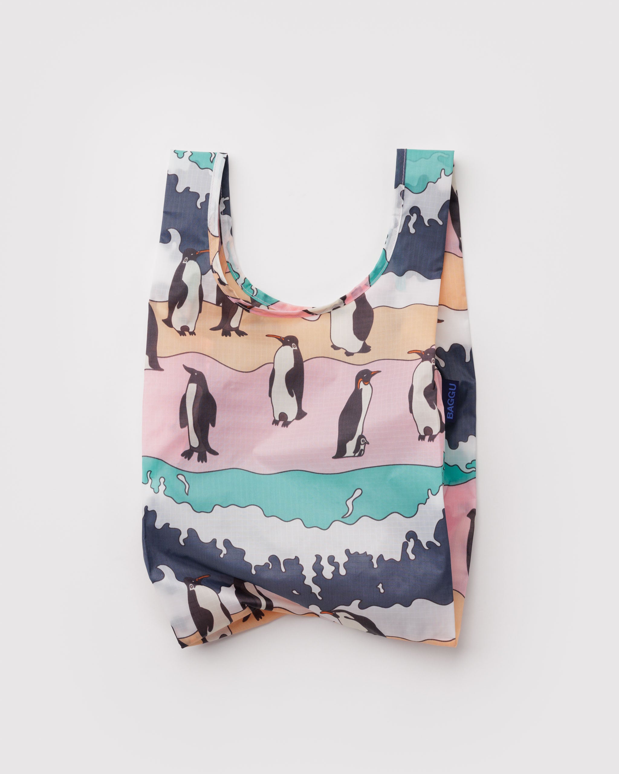 Reusable shopping bag with penguin design and pink, green and grey background