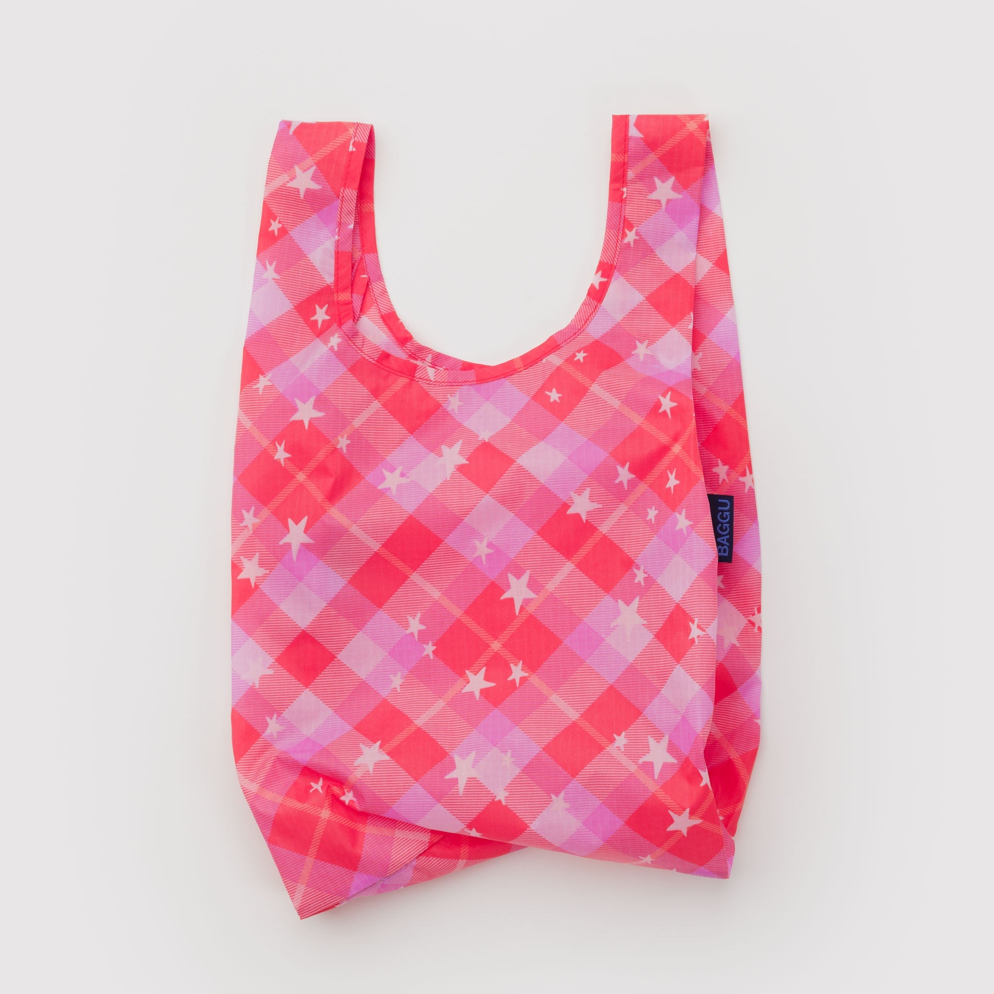 Reusable shopping bag with pink and purple checkered pattern with white stars.