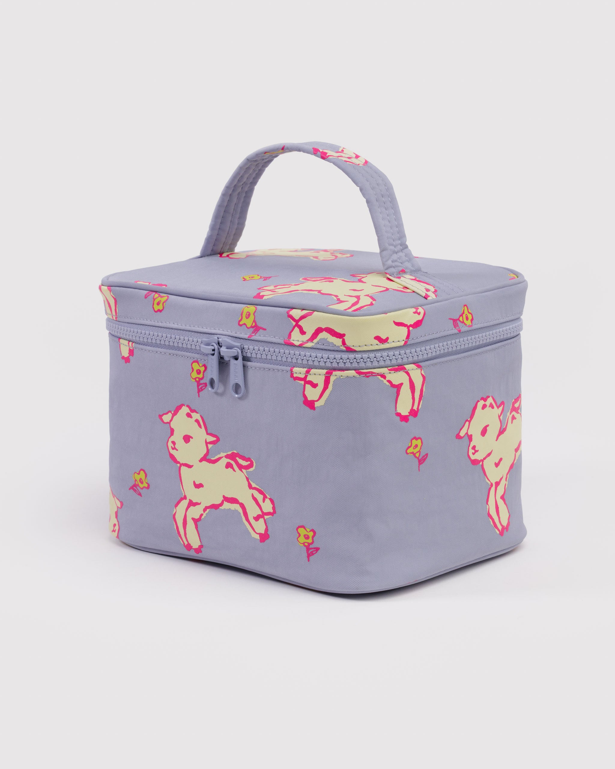 Blue cosmetic bag with tonal zippers and a pink outline around white jumping lambs pattern with a carry handle on top lid.