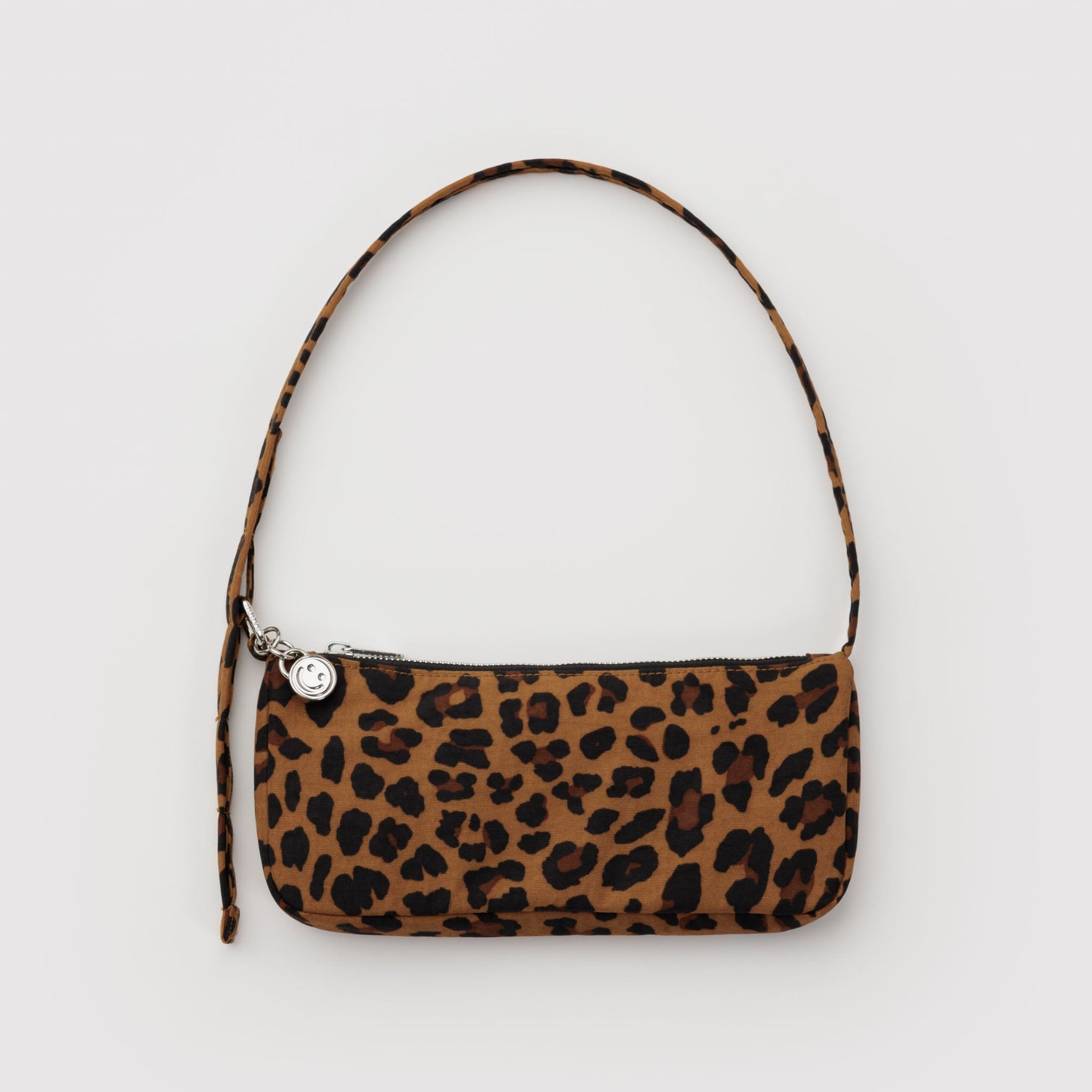 Small Leopard print handbag with adjustable shoulder strap with metal hardware, clasp, zip and smiley face charm.