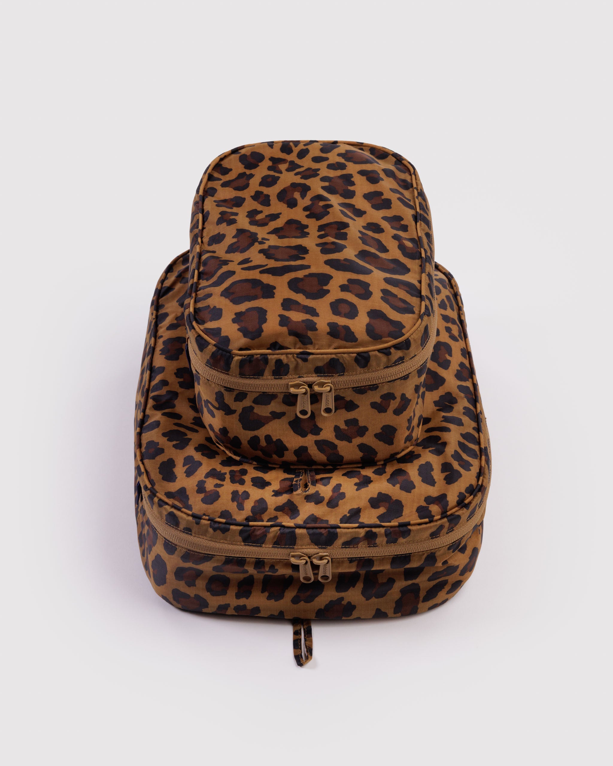 Leopard print travel packing cubes set in small and medium size with all around tonal zippers.