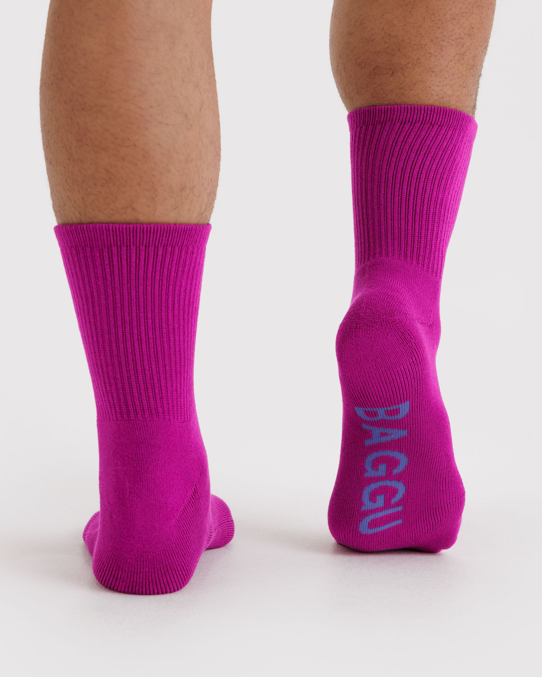 Hot pink ribbed socks with 'BAGGU' branding on the sole.