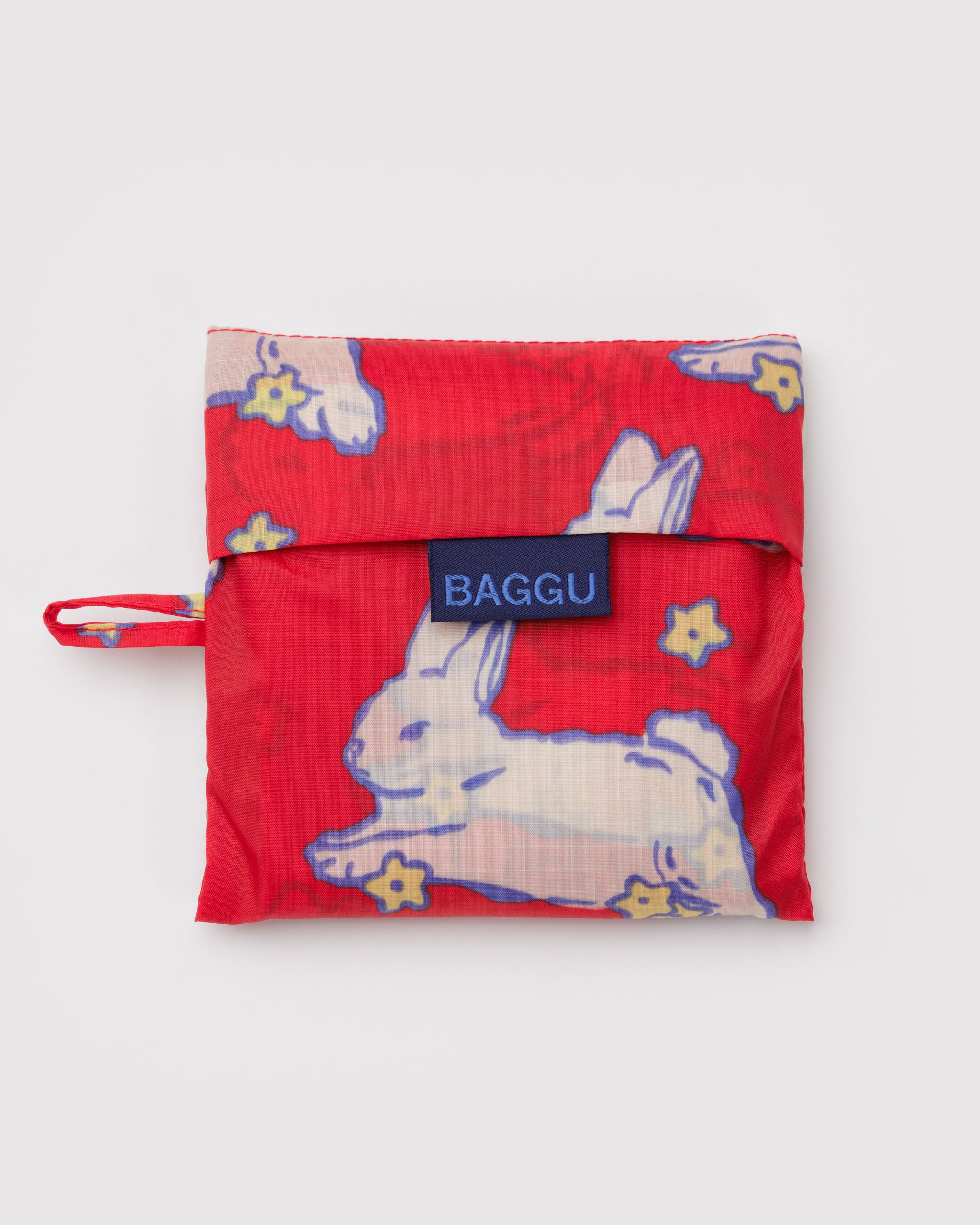 Red pouch with bunny design, 'Baggu' brand label and hanging loop