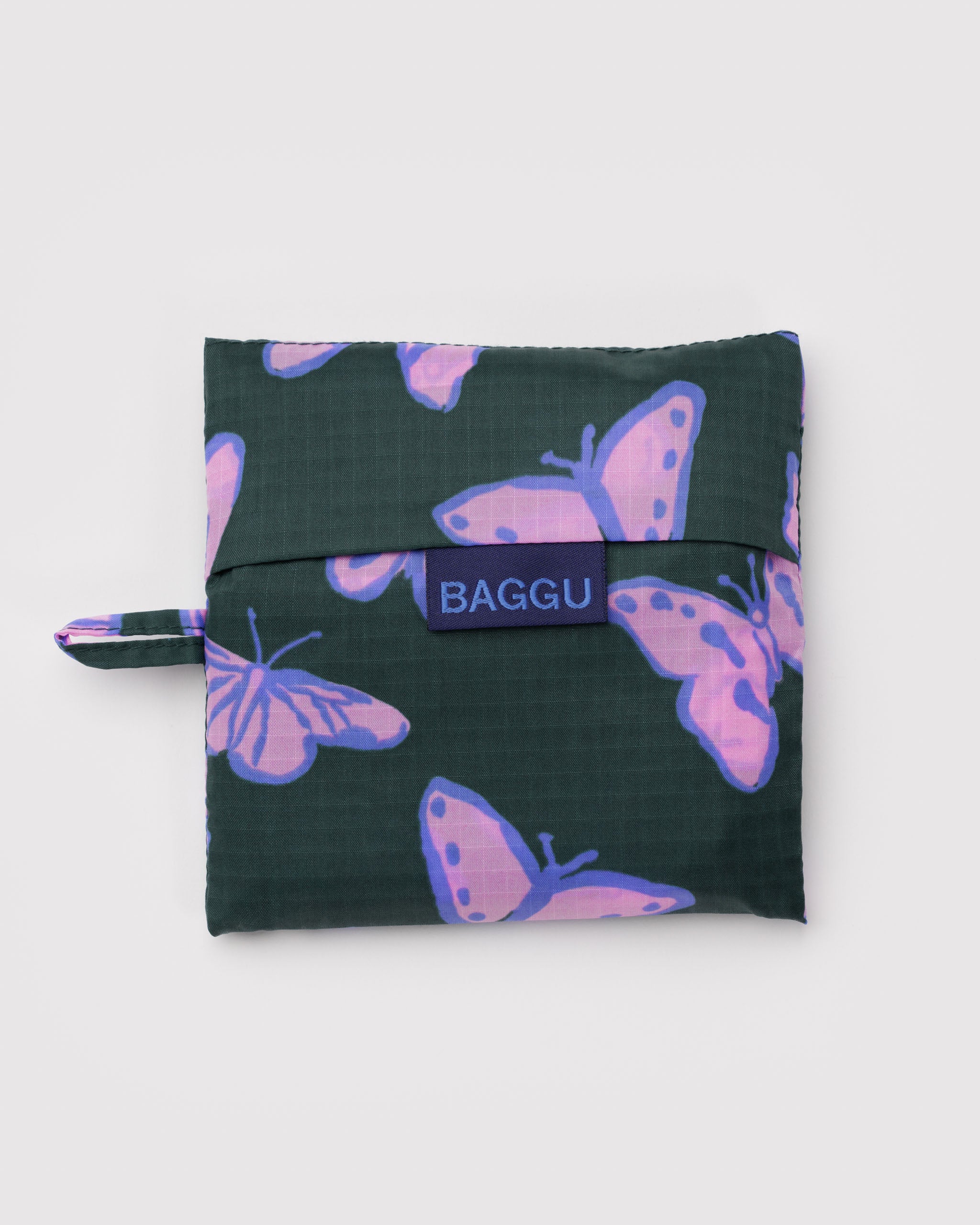 Green pouch with purple butterfly pattern and 'BAGGU' logo and hanging loop at the side.