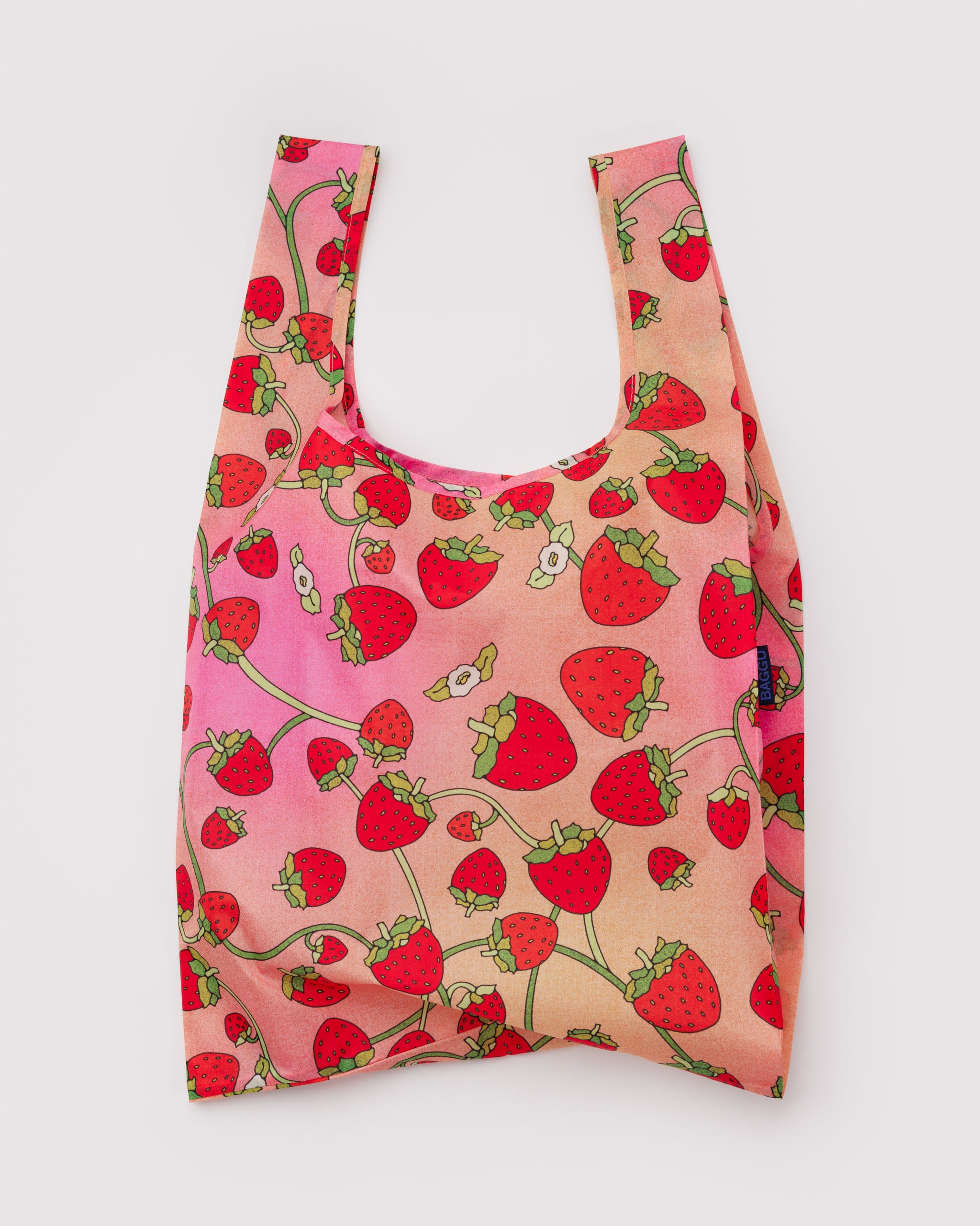 Reusable tote bag with strawberry pattern and white blossoms.
