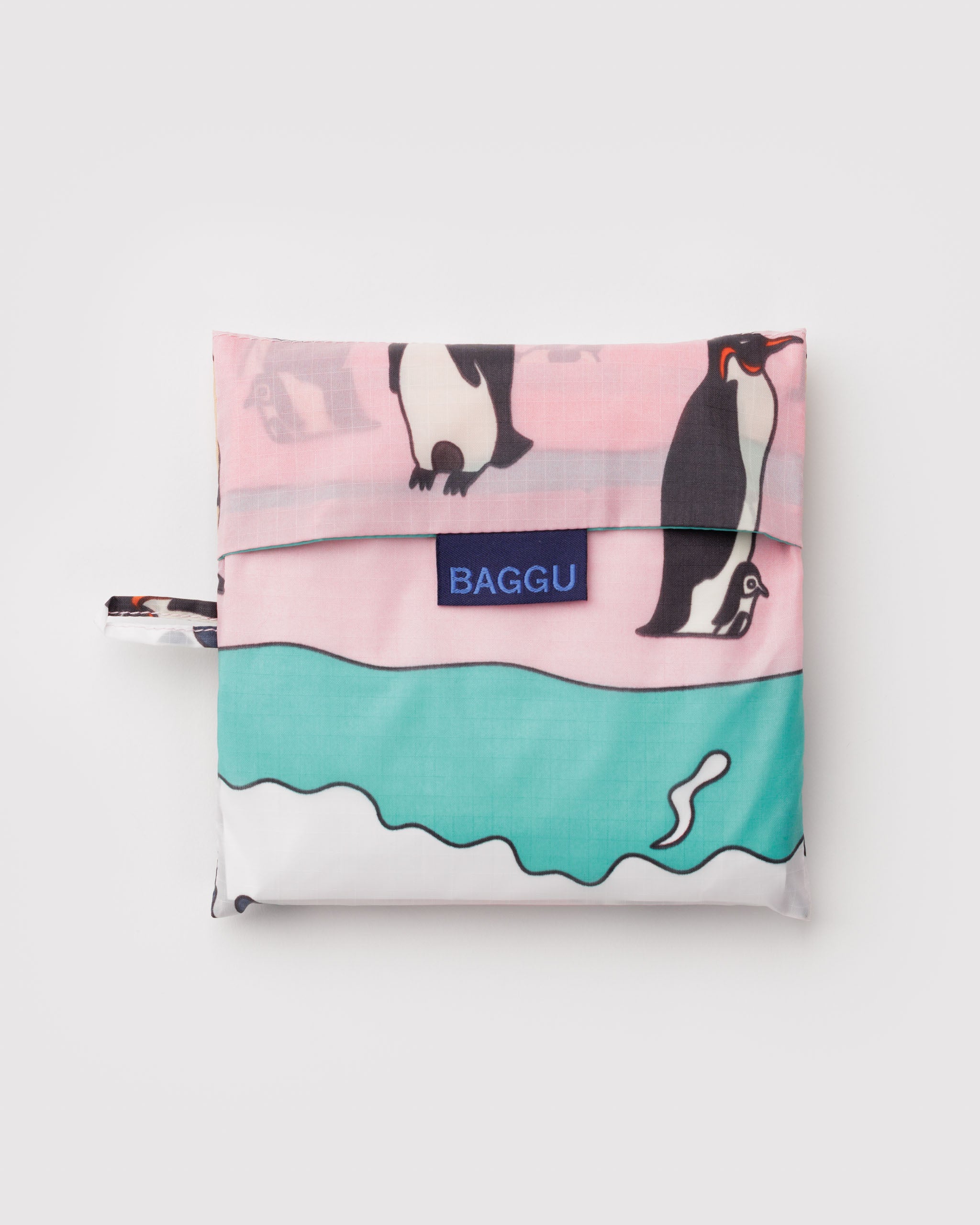 Foldable shopping bag with penguin design and 'BAGGU' branding and hanging loop