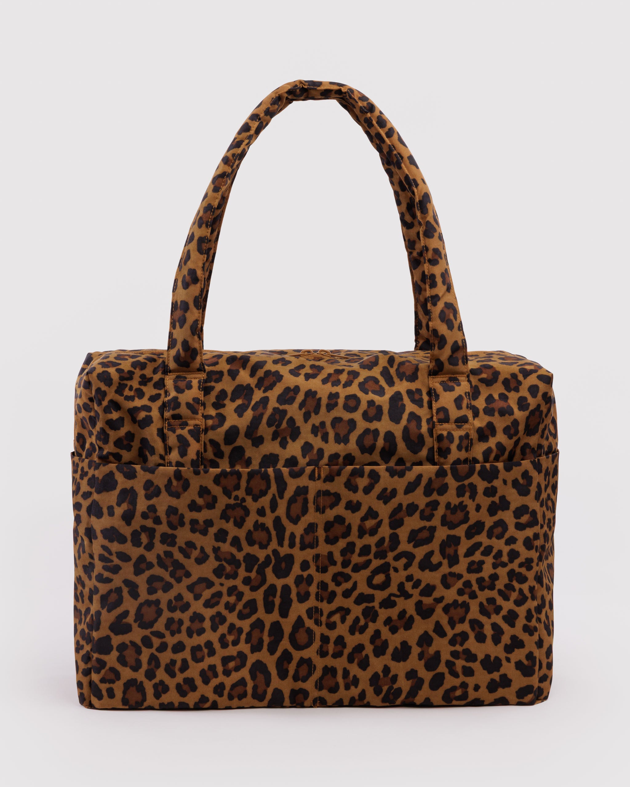 Leopard print duffle bag with front pockets and carry handles.