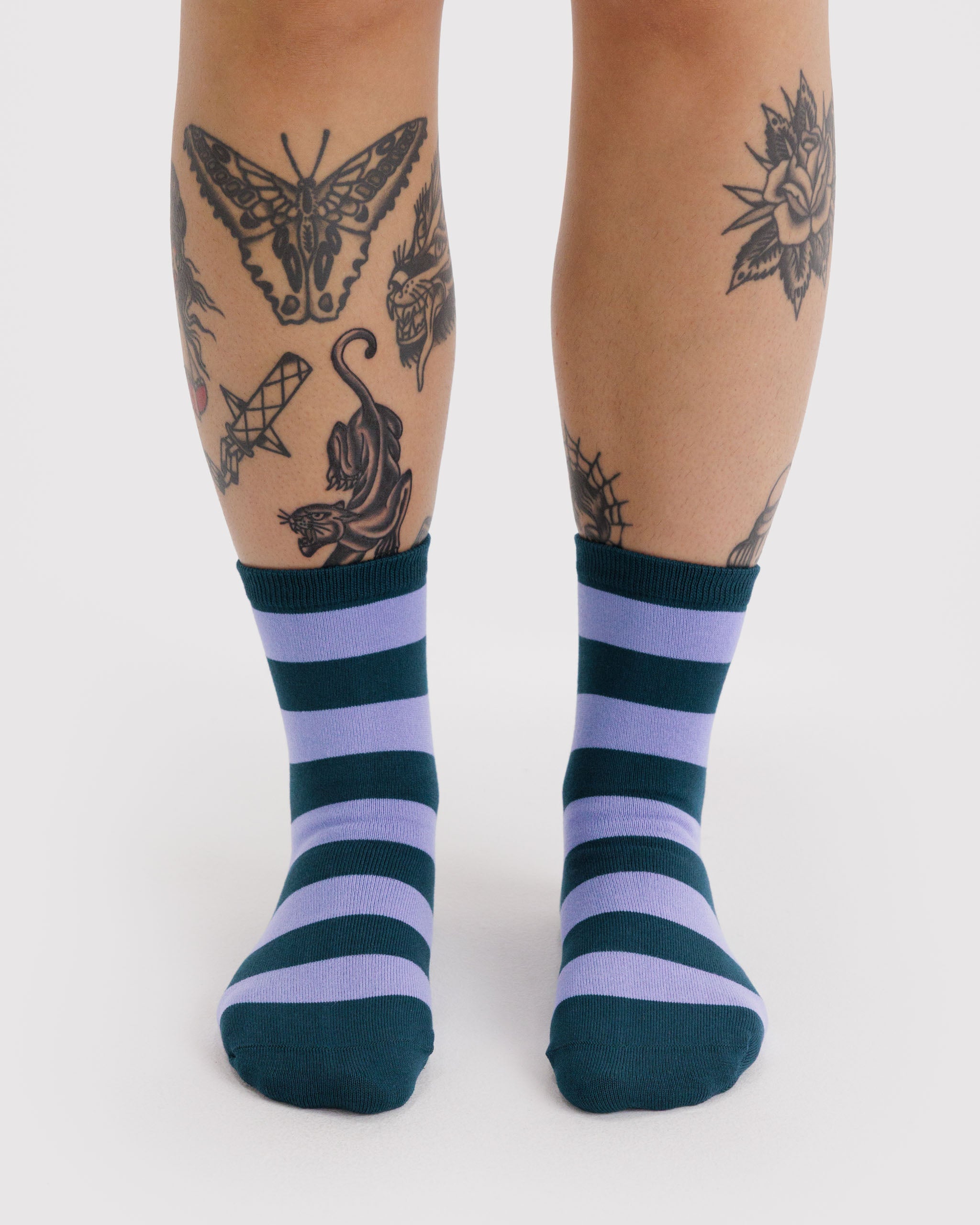 Person wearing striped crew socks.