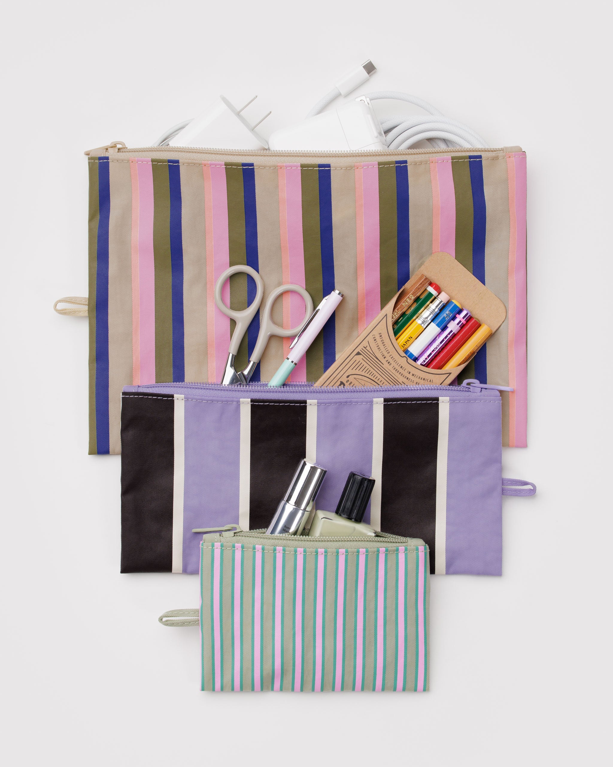 Pastel multi coloured and striped zip top flat pouches with stationery inside and a hanging loop at the side.