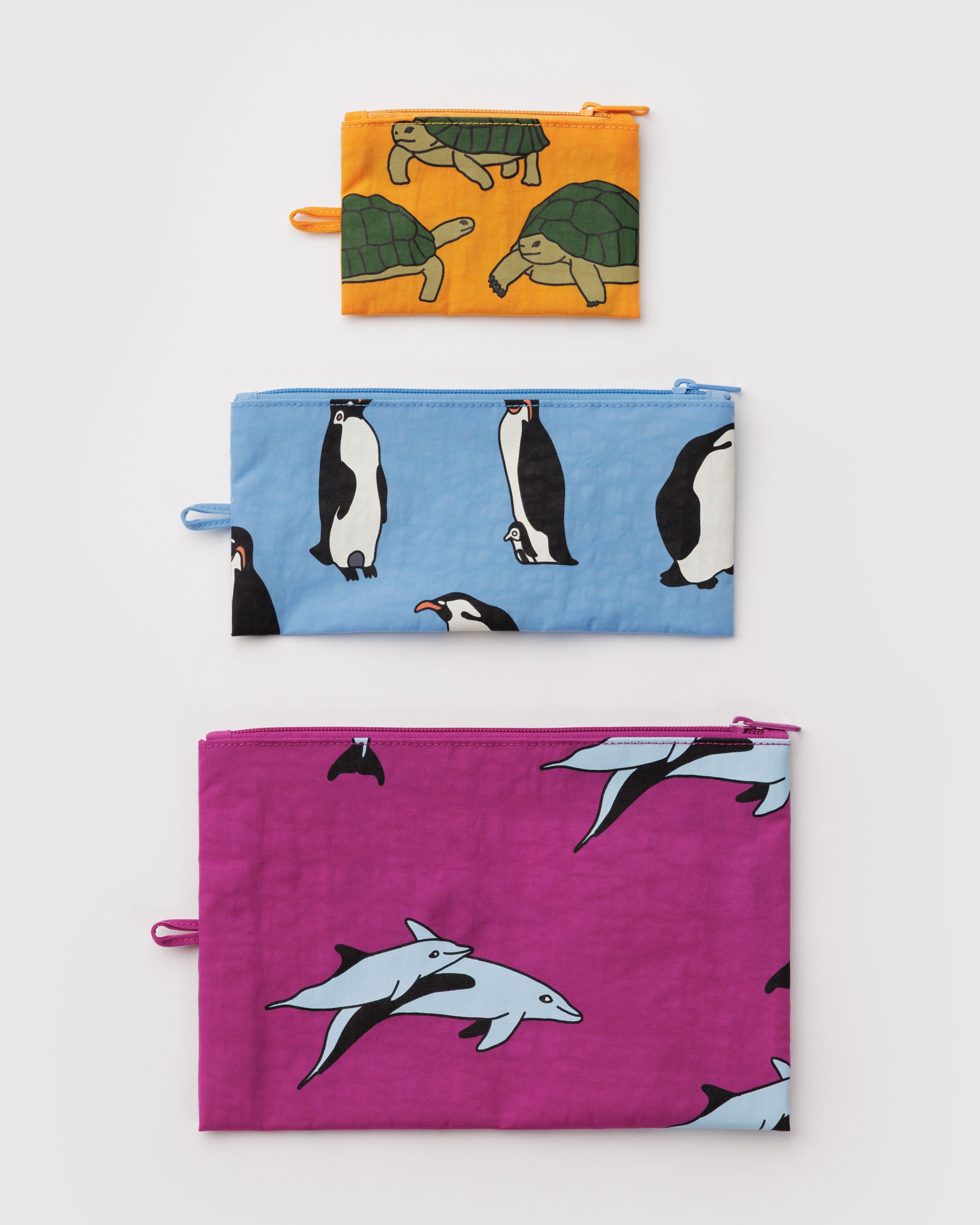Three zip top fabric pouches with animal patterns in a small, medium and large size with a hanging loop at the side.