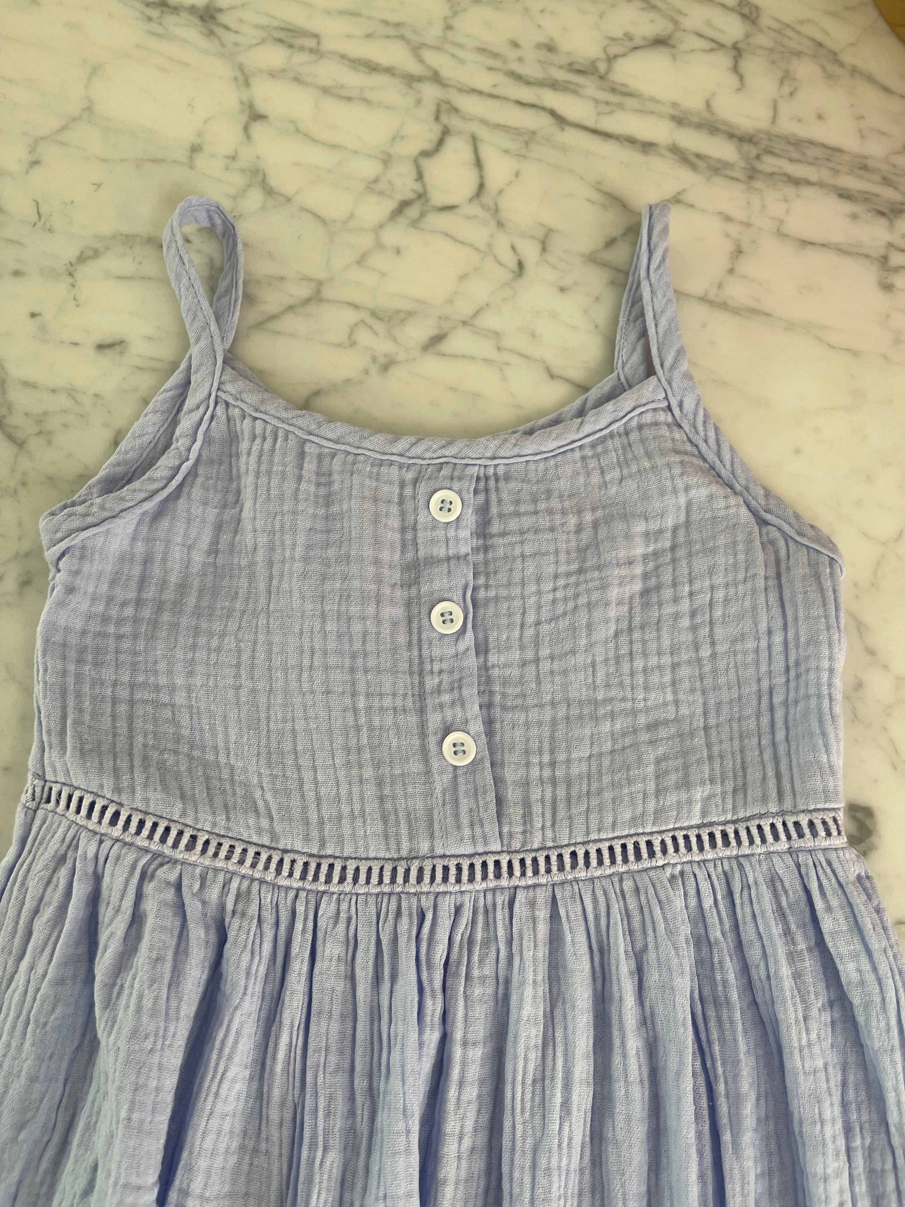 top-section-of-girls-blue-cotton-dress-lying-on-a-table
