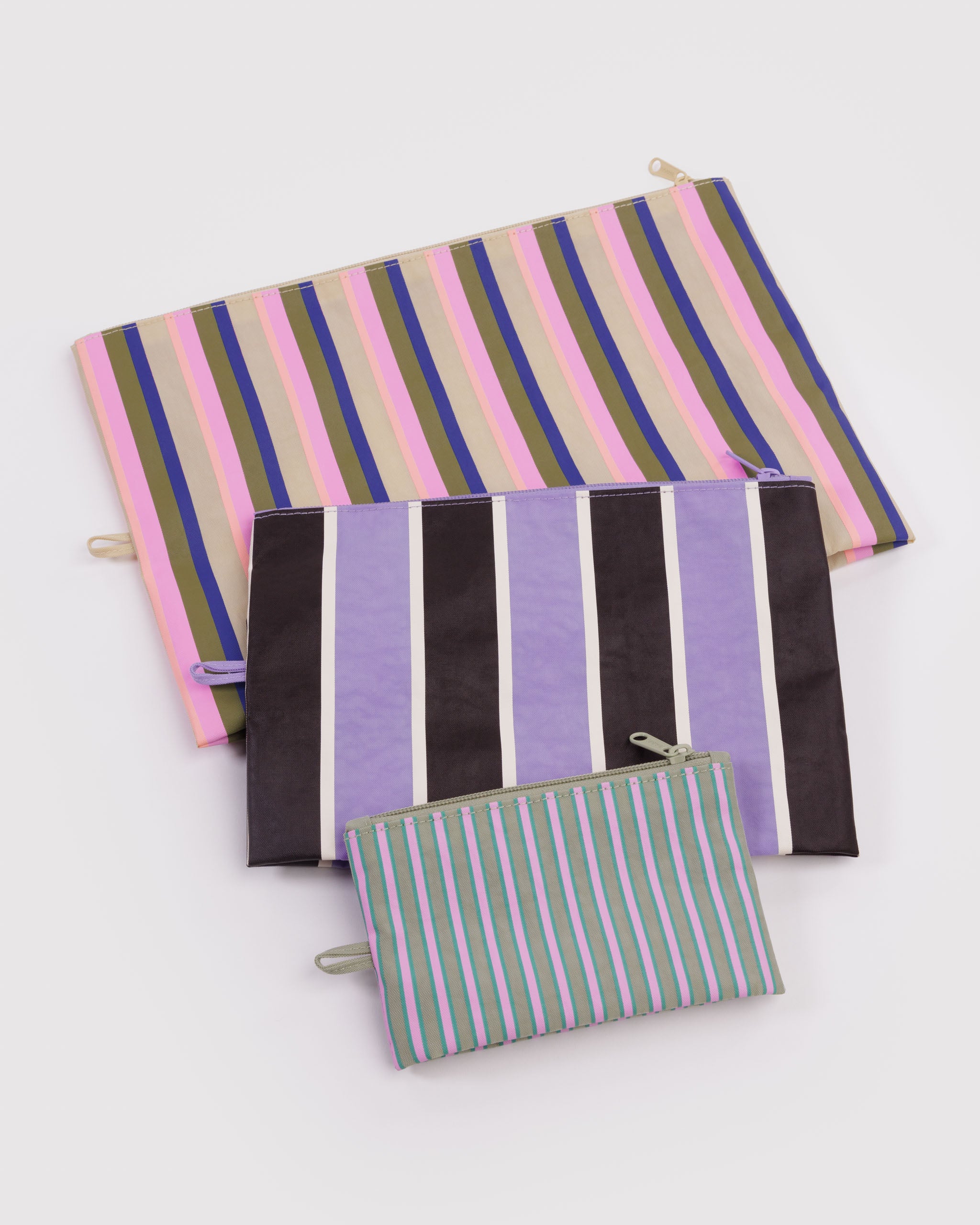 Set of striped pouches with zip top and hanging loop at the side lying flat.