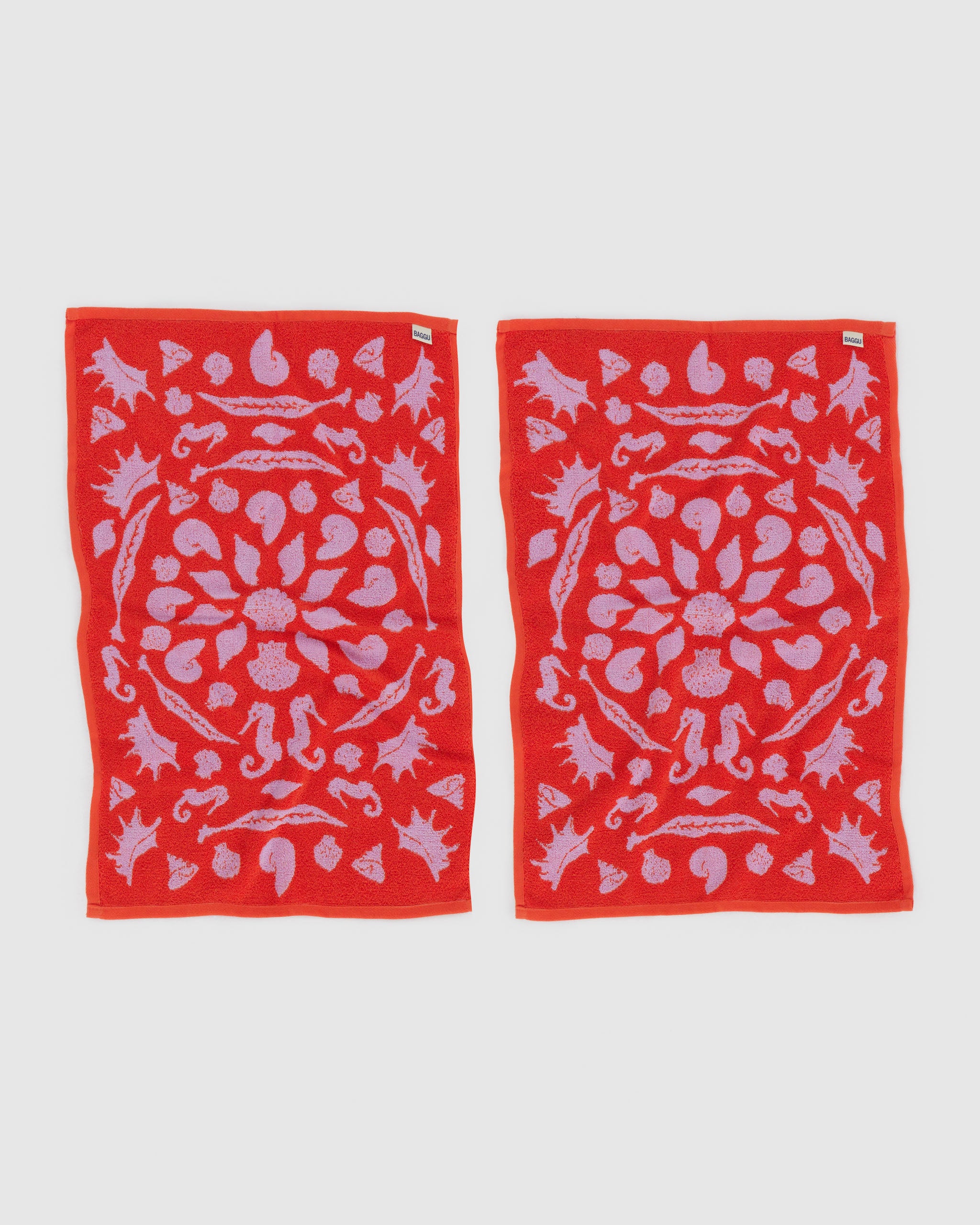 shell-pattern-on-hand-towels-set-of-two-red-and-pink-reversible-colours-back-side-with-brand-label