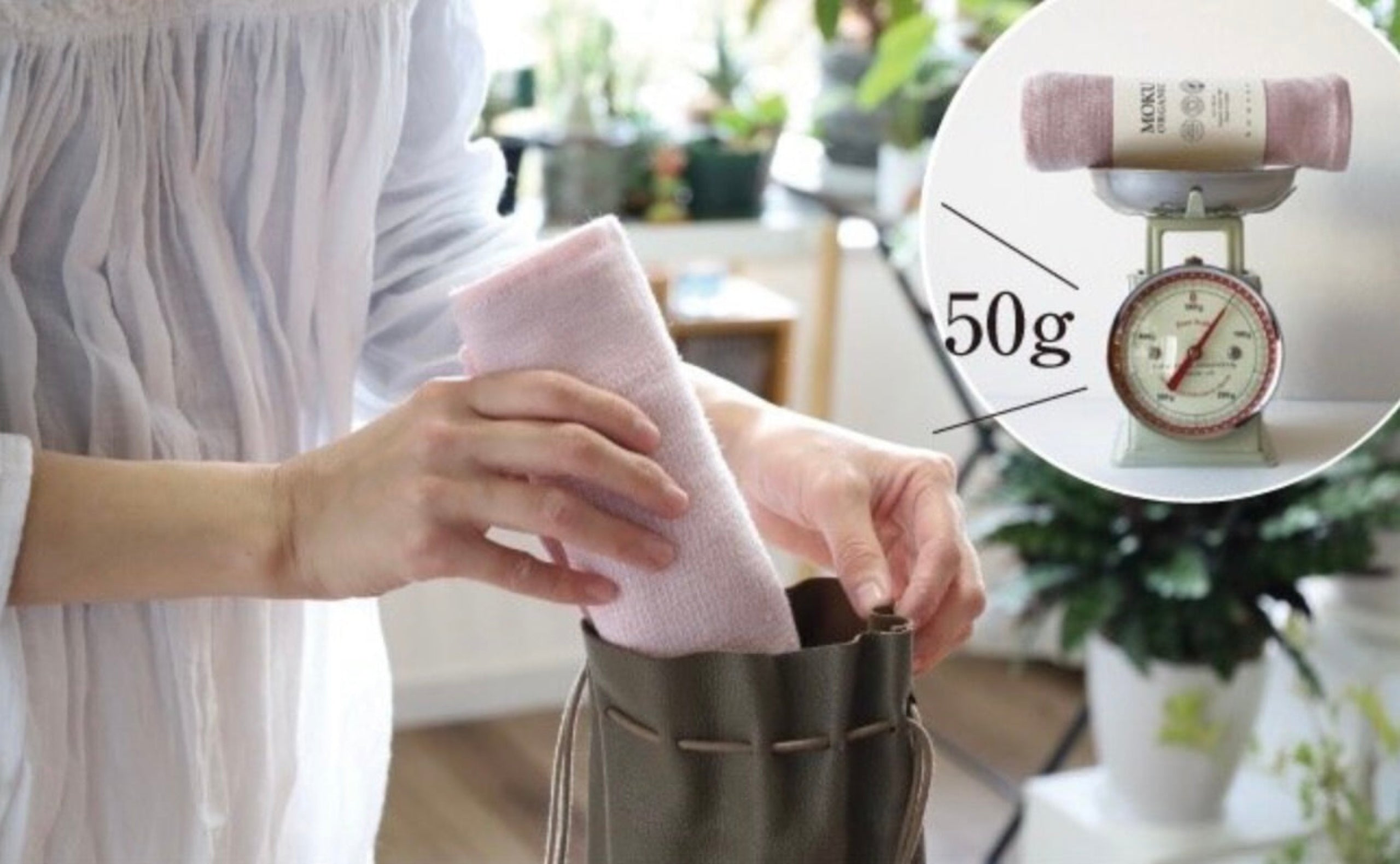 Person holding a pink towel and placing in a bag with a close-up of a scale showing 50g weight.