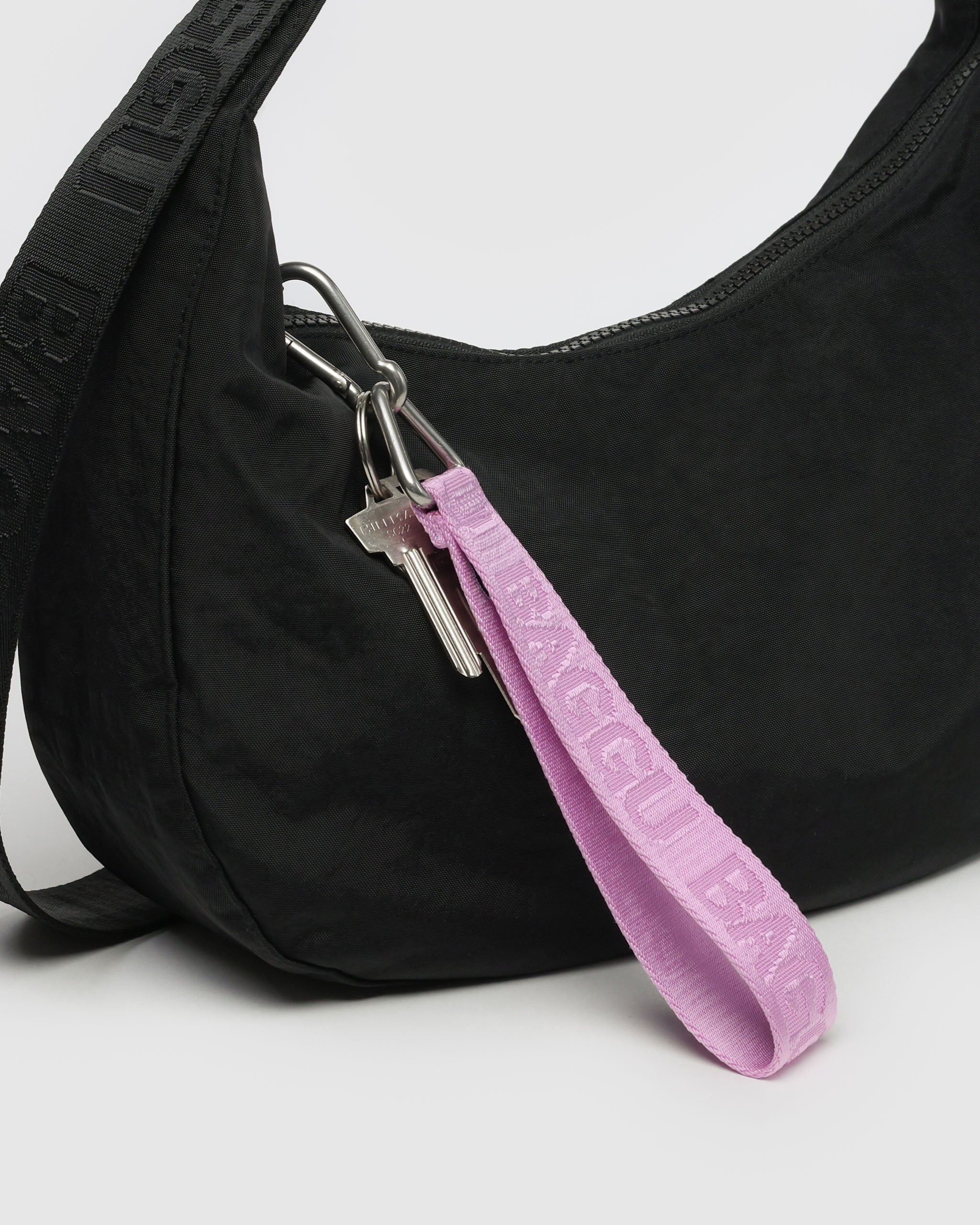 pink-keychain-attached-to-black-handbag