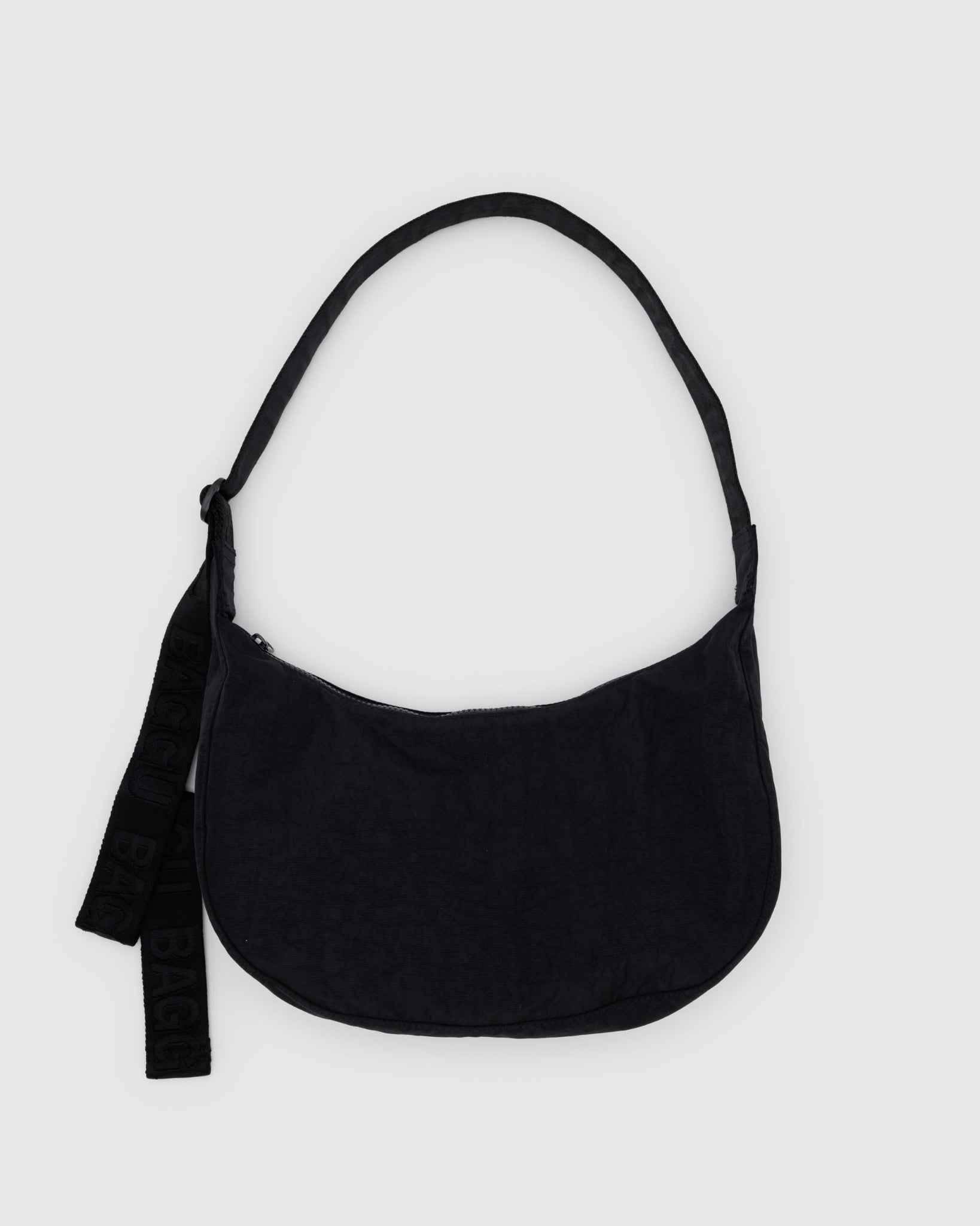 Black shoulder bag with zip top and adjustable black webbed shoulder strap.