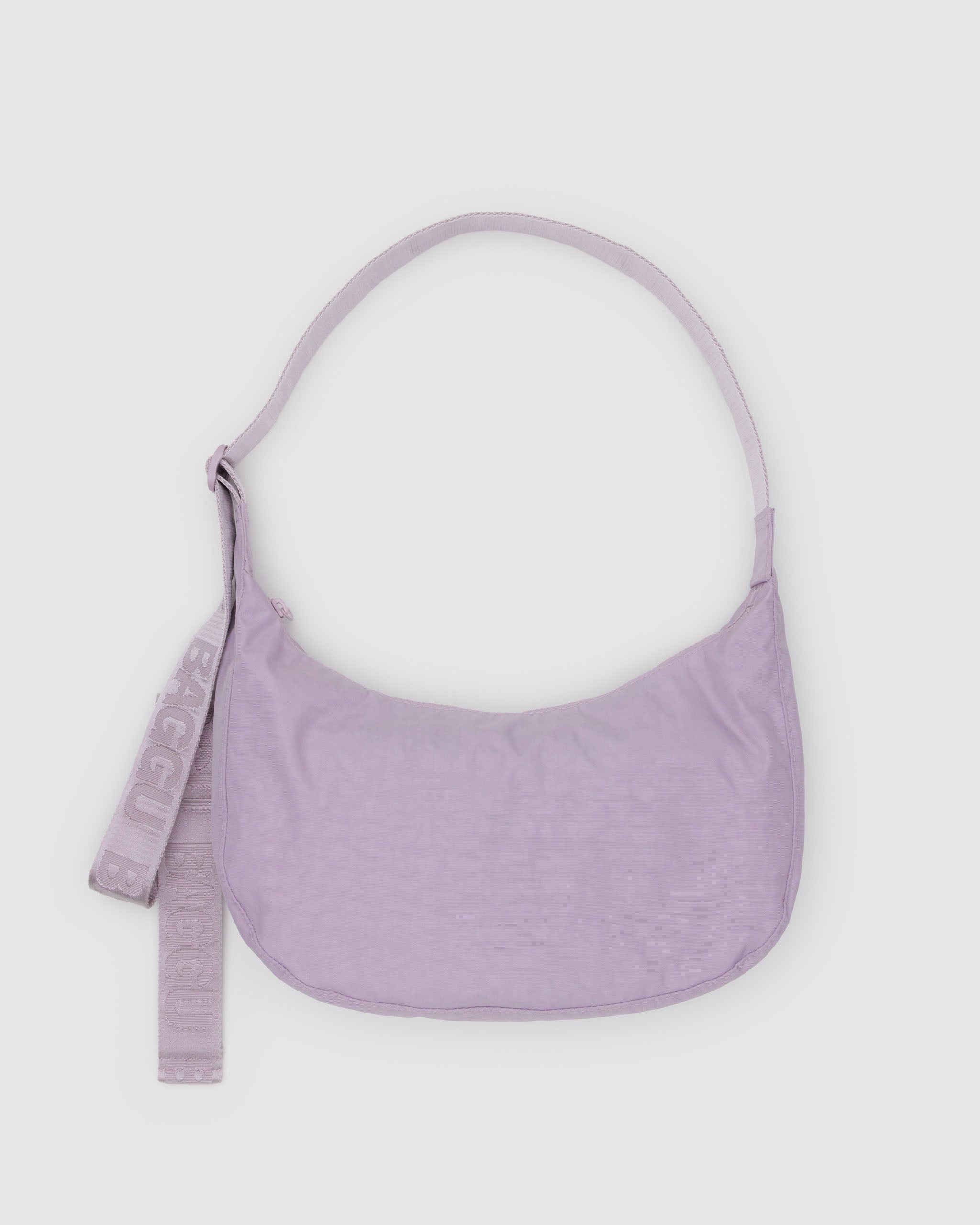 dusty-pink-medium-crescent-shoulder-bag-with-tonal-long-baggu-branded-adjustable-crossbody-strap-flatlay