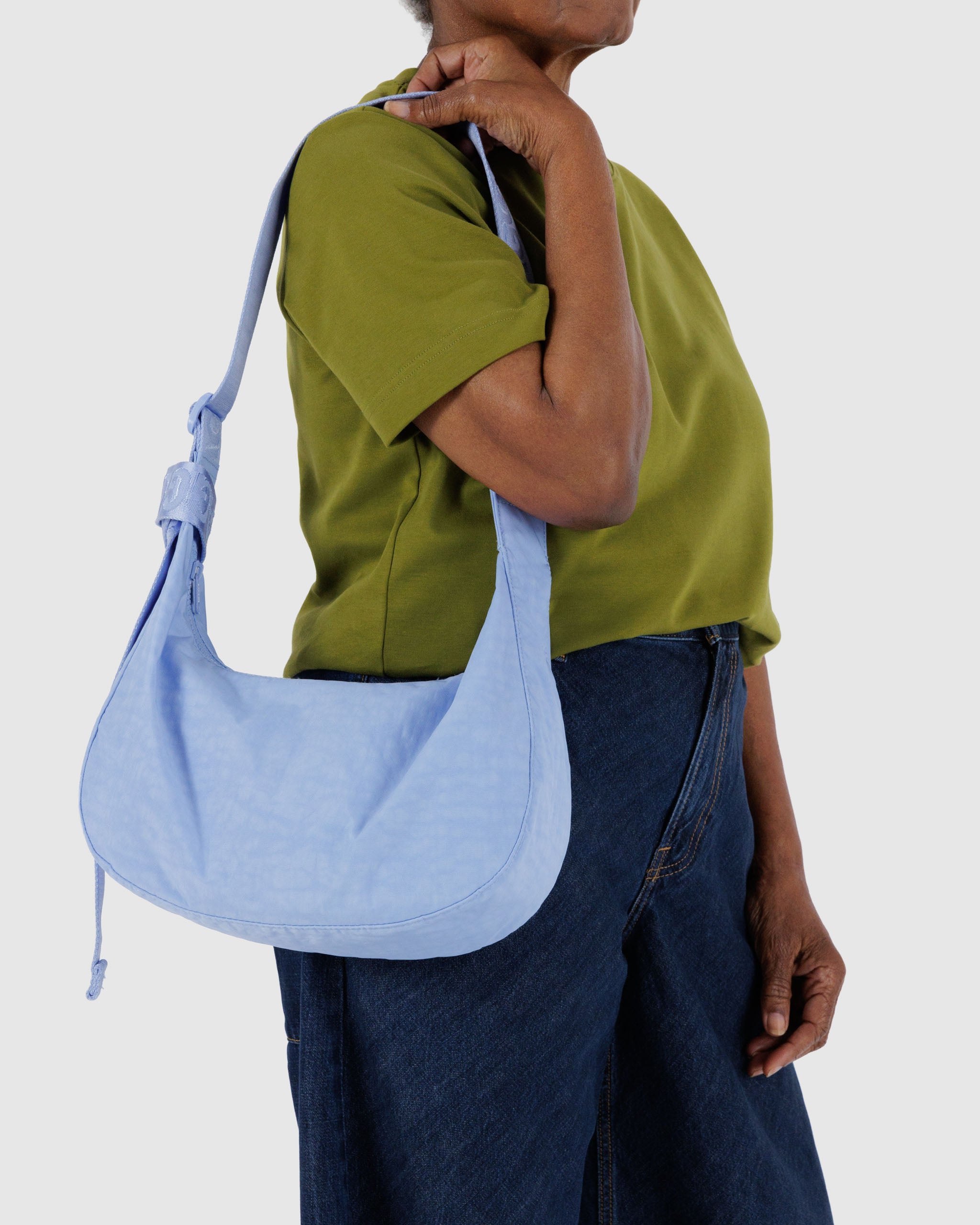 woman-wearing-french-blue-coloured-medium-nylon-crescent-bag-with-adjustable-strap-on-shoulder