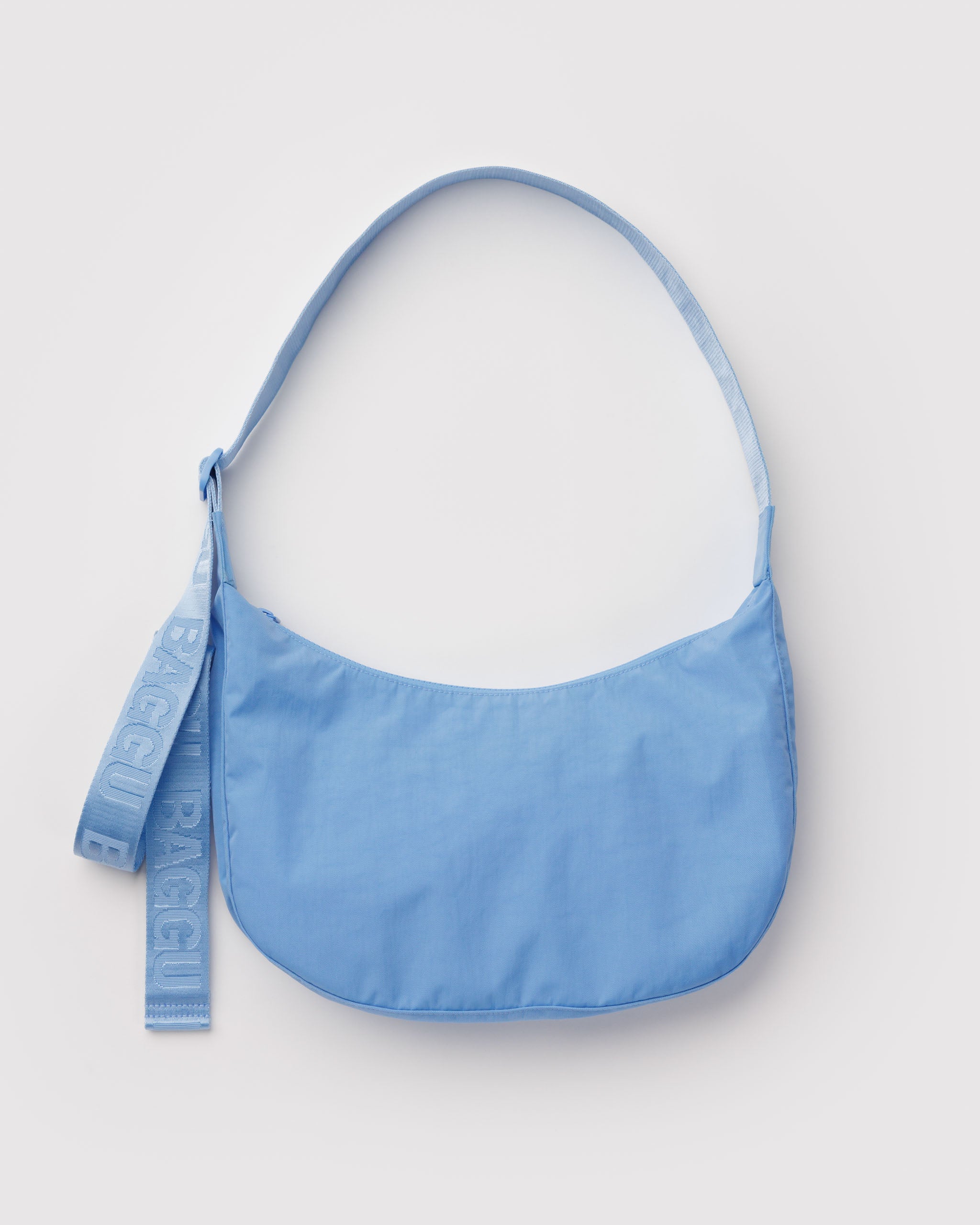 Blue shoulder bag with adjustable crossbody strap.