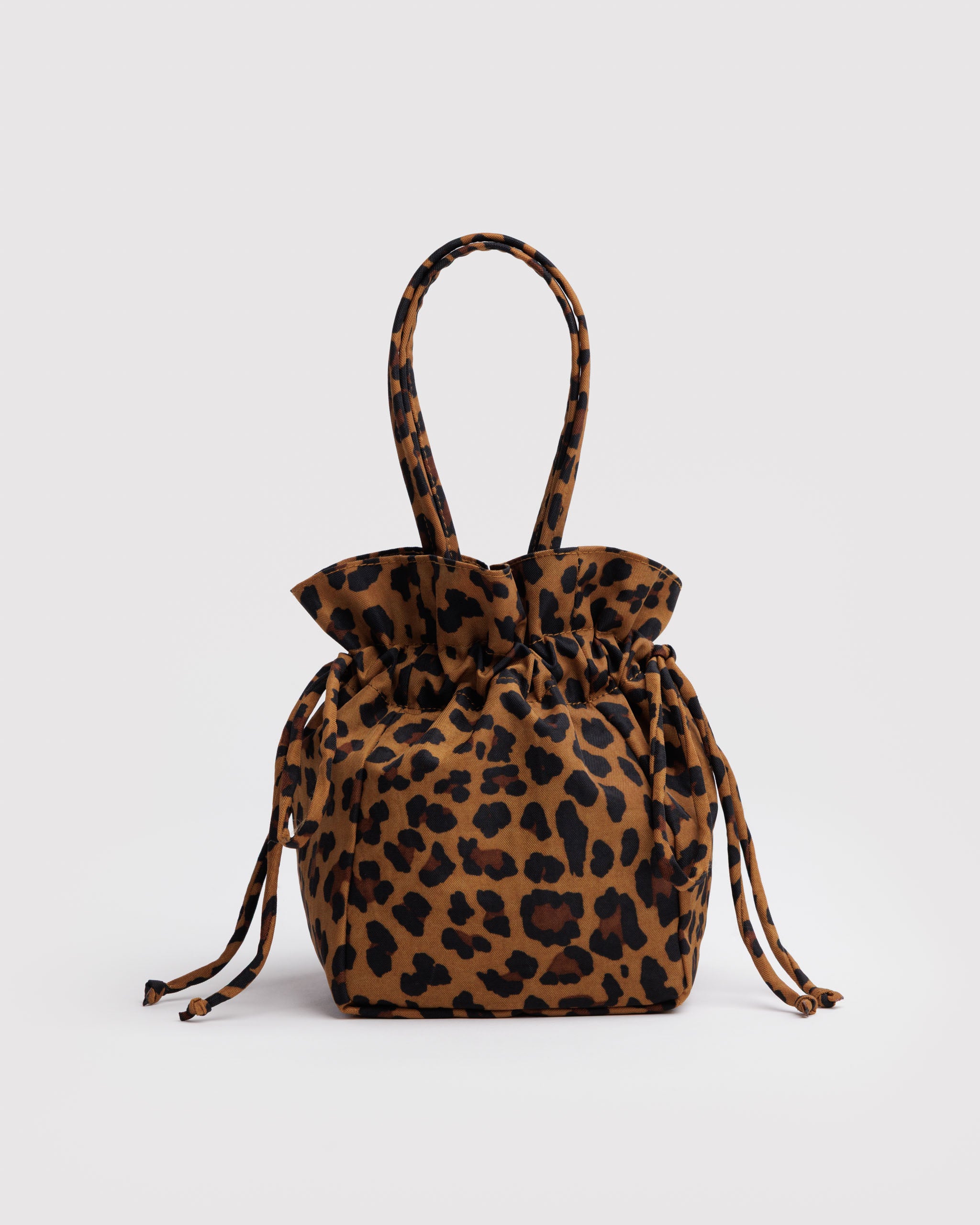 Leopard print drawstring bag with carry handles.