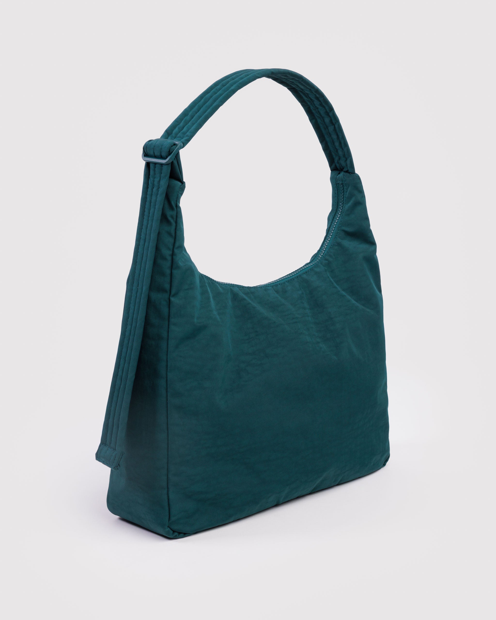 Teal handbag with top zipper and adjustable, quilted shoulder strap.