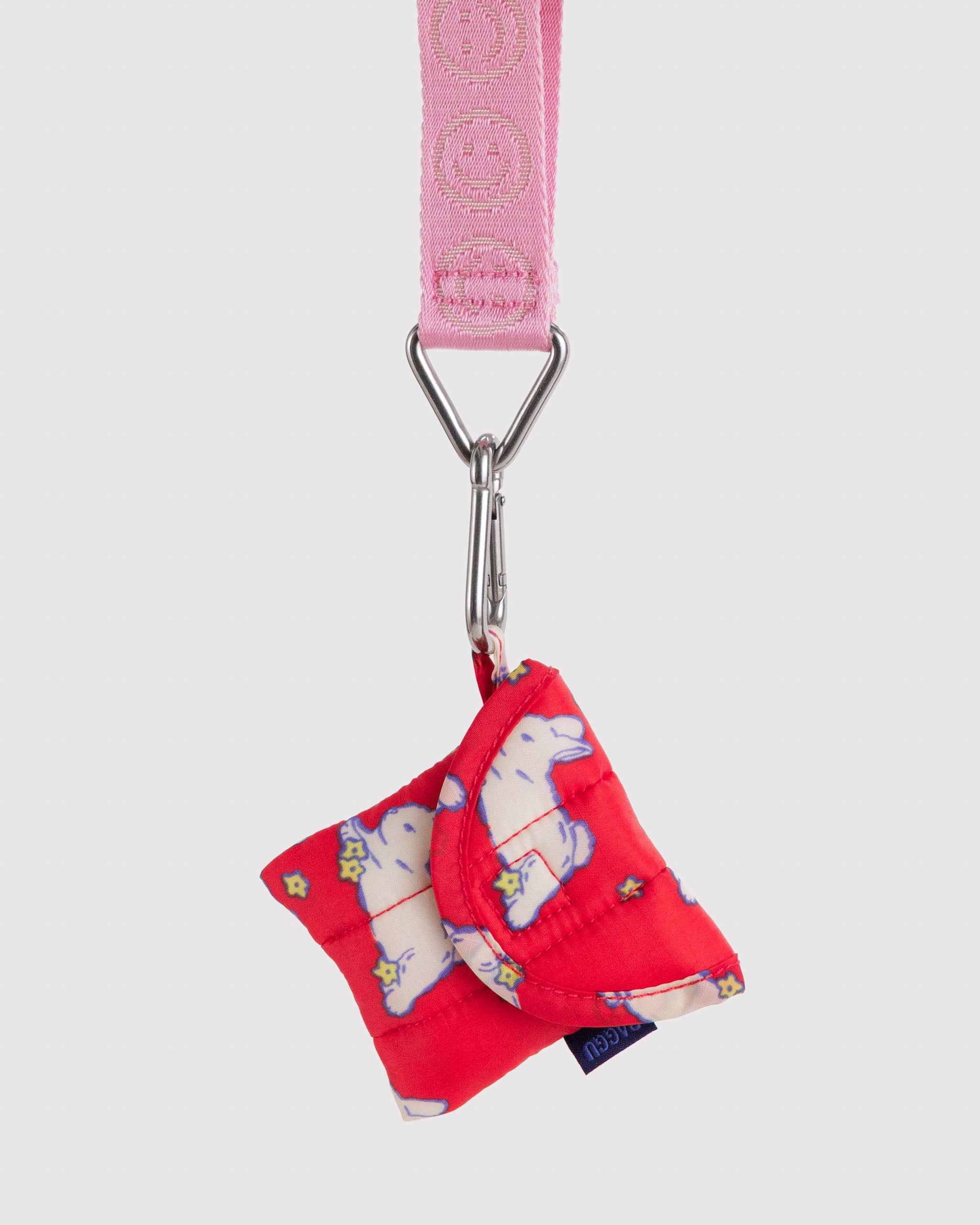 Red pouch with white bunnies design attached to a pink logo keychain by hanging loop.