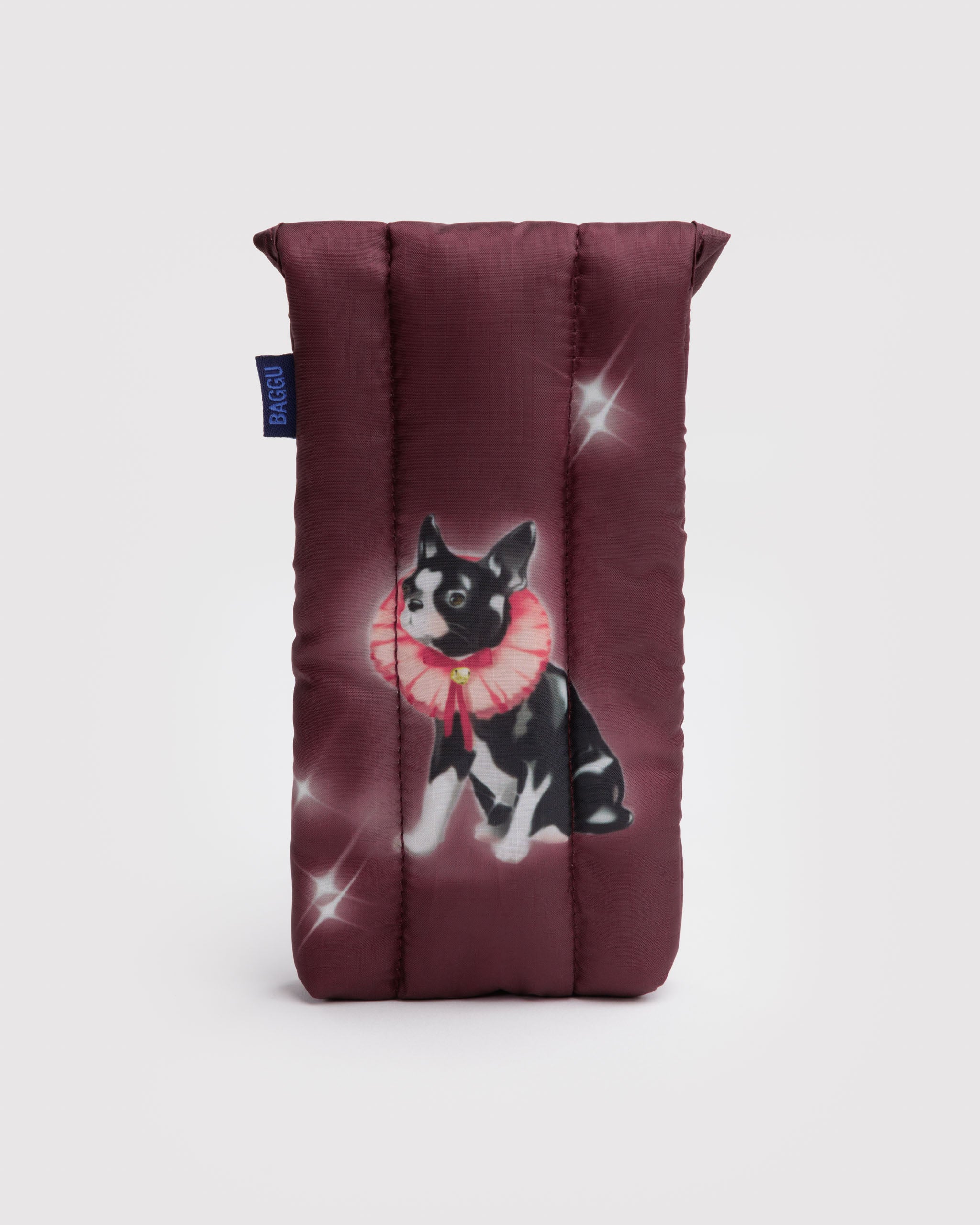 Back of maroon quilted sunglasses sleeve with a fancy black dog and sparkles and BAGGU label at the side.