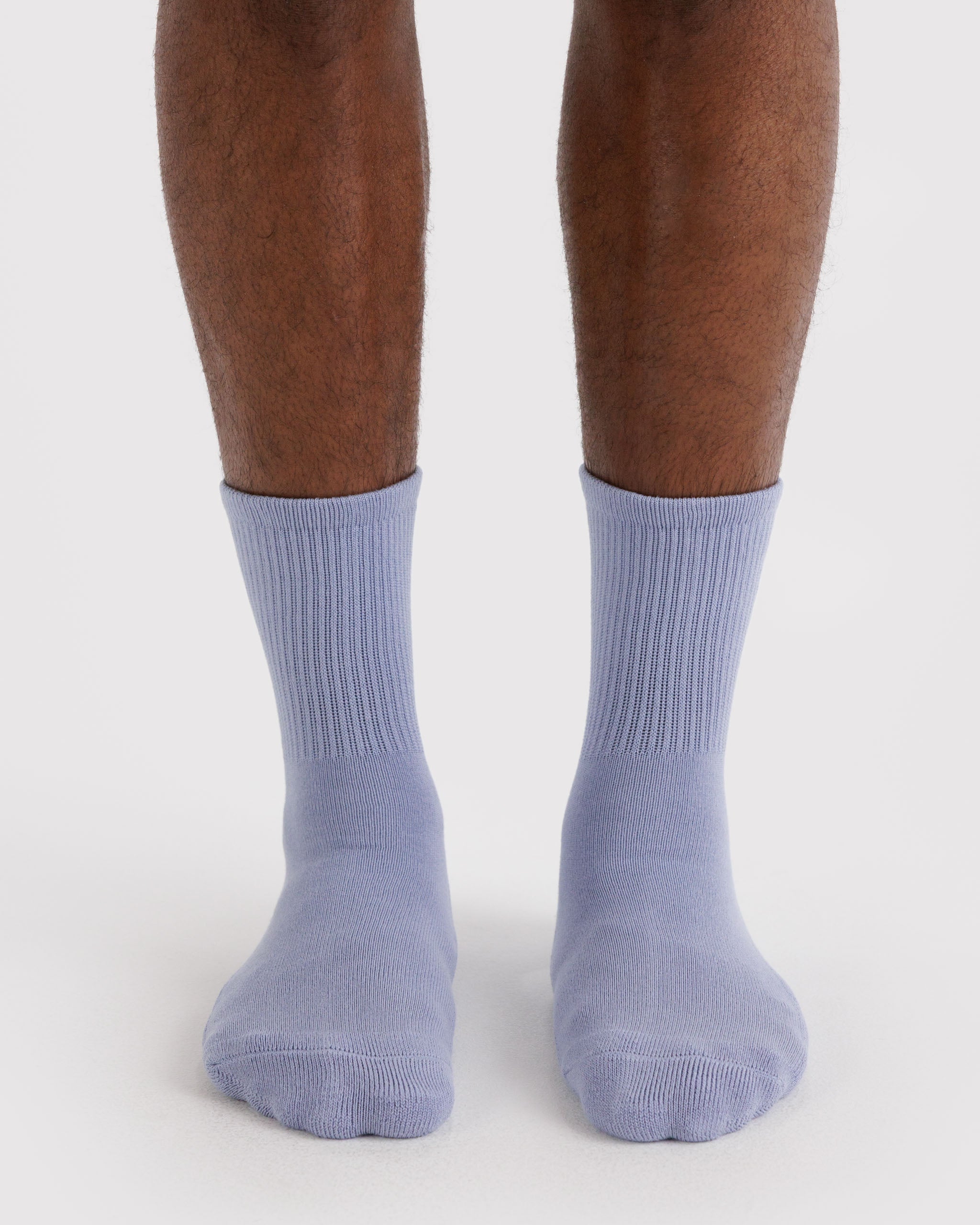 Man wearing light blue ribbed socks.
