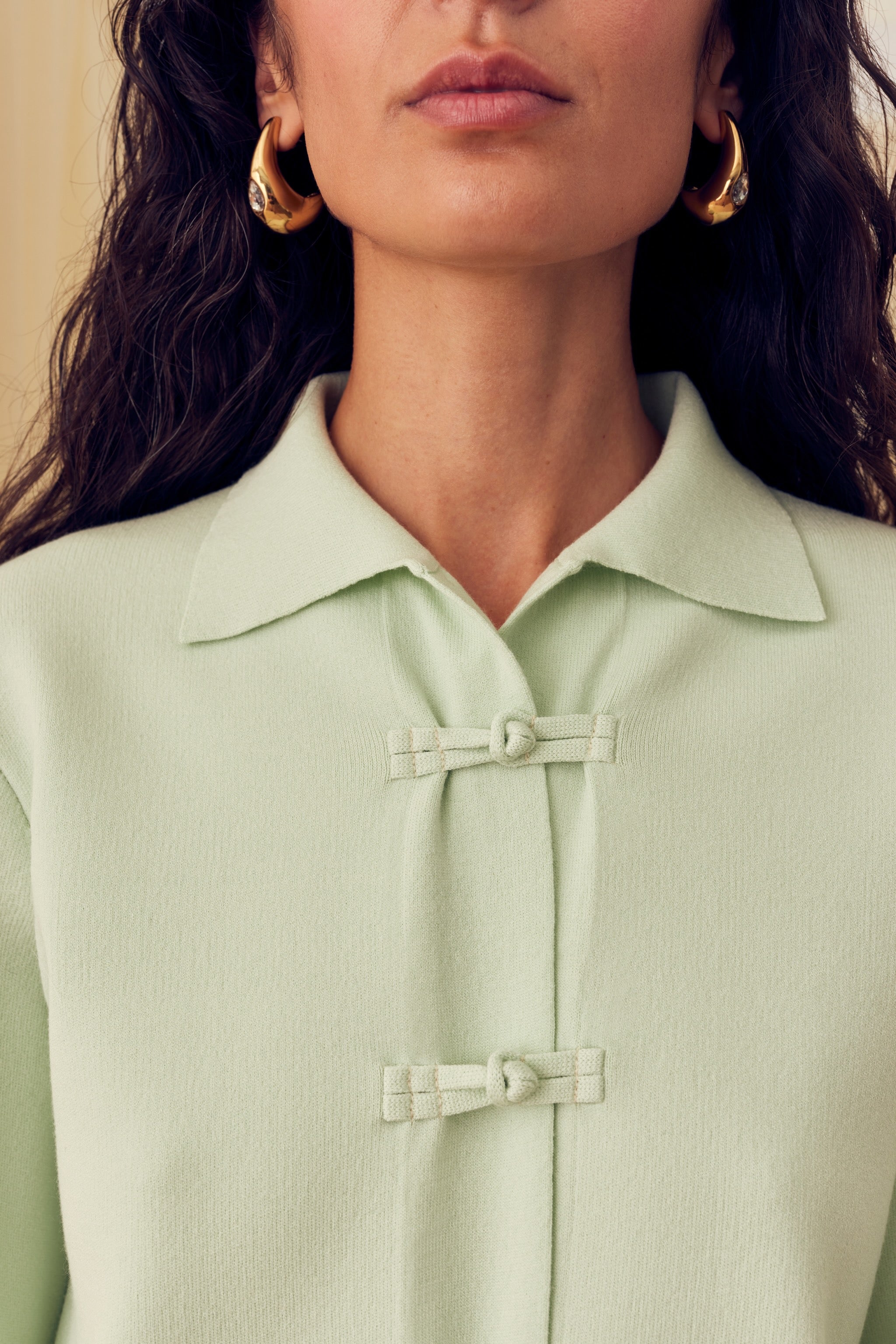 woman-wearing-mint-knitted-cardigan-with-collar-and-frog-fasteners