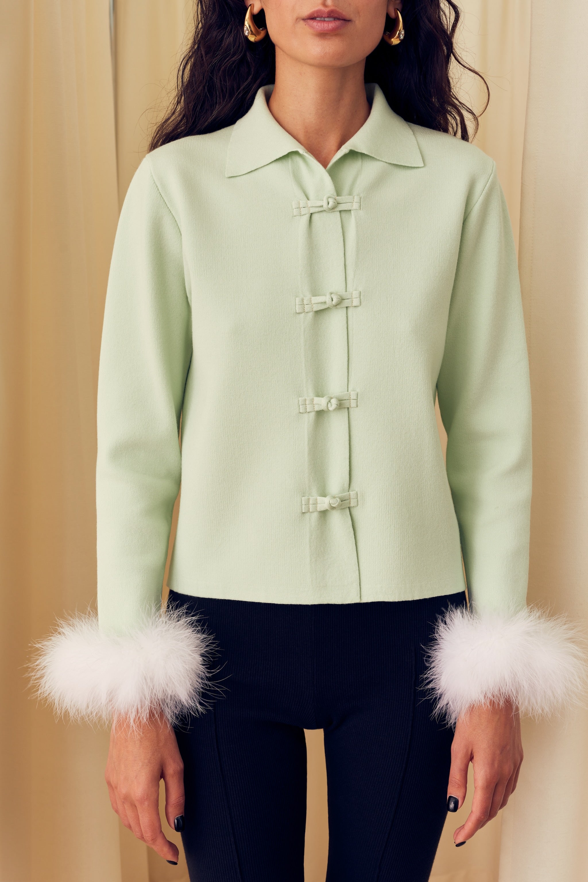 woman-wearing-mint-knitted-cardigan-with-white-detachable-feather-cuffs