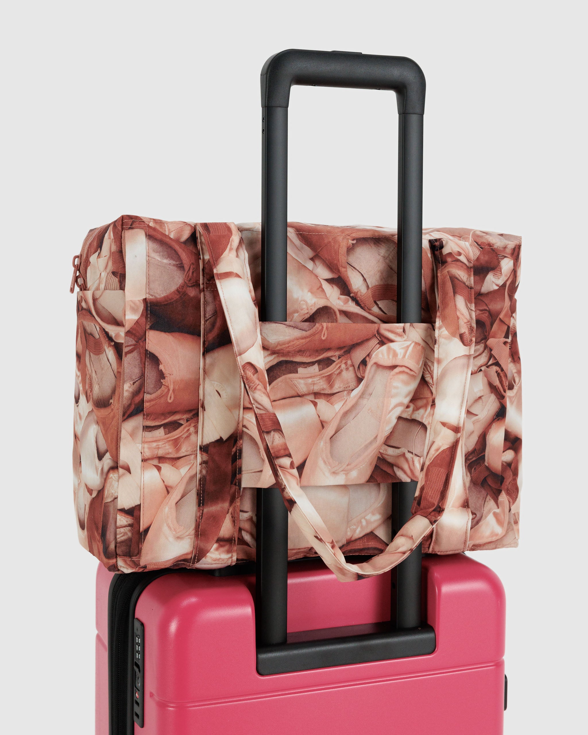 small-cloud-carry-on-pointe-shoe-print-with-luggage-trolley-sleeve-attached-to-pink-suitcase