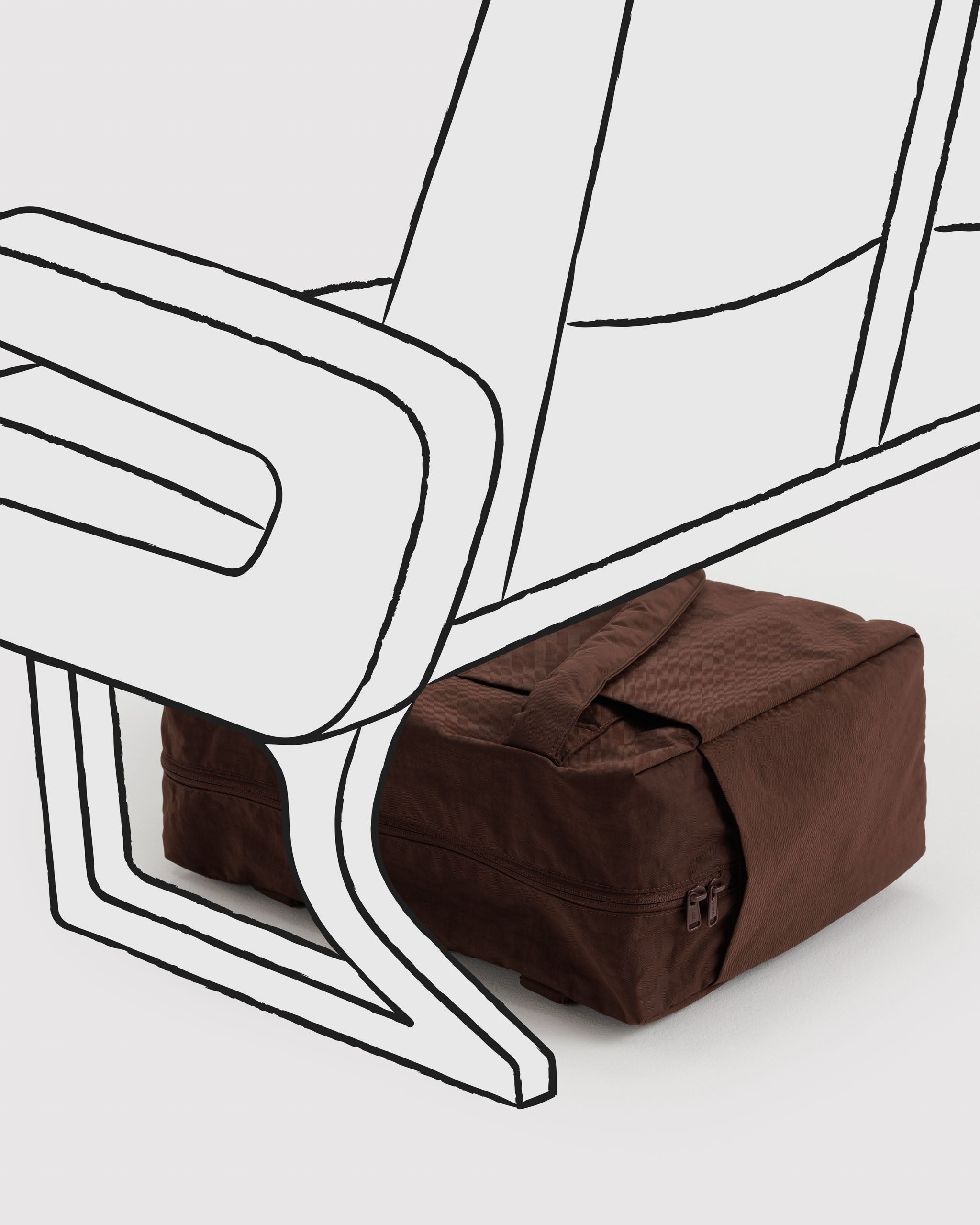 Brown duffle bag under a white airplane chair.